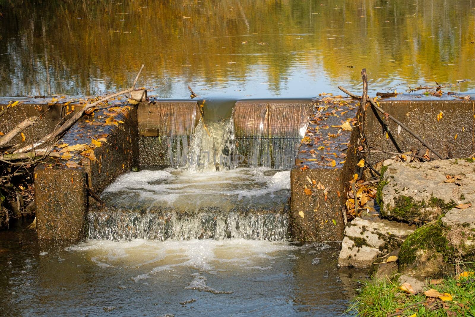 Build structure waterfall in autumn water reflection