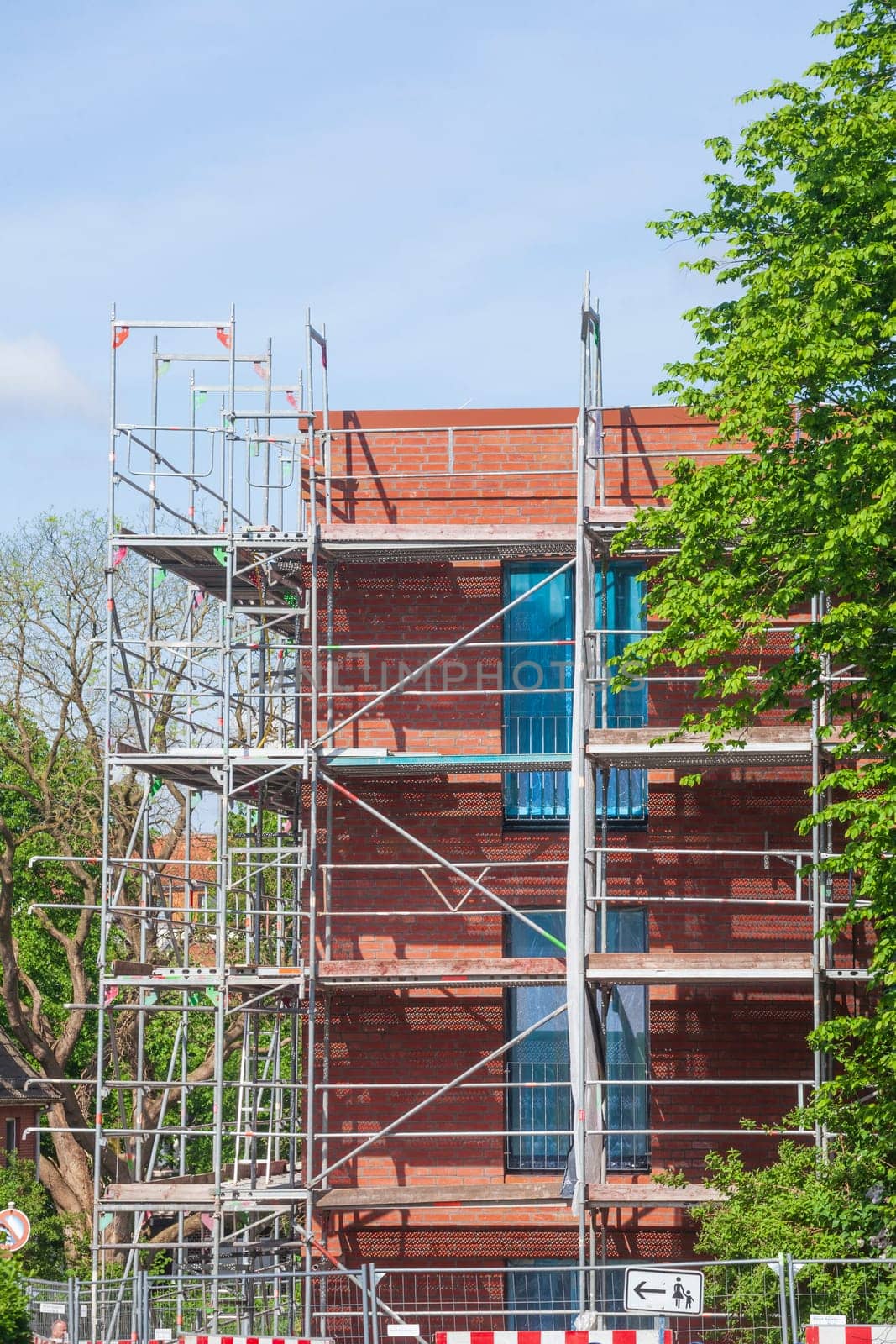 Scaffolding on the shell of a red brick residential building, Germany