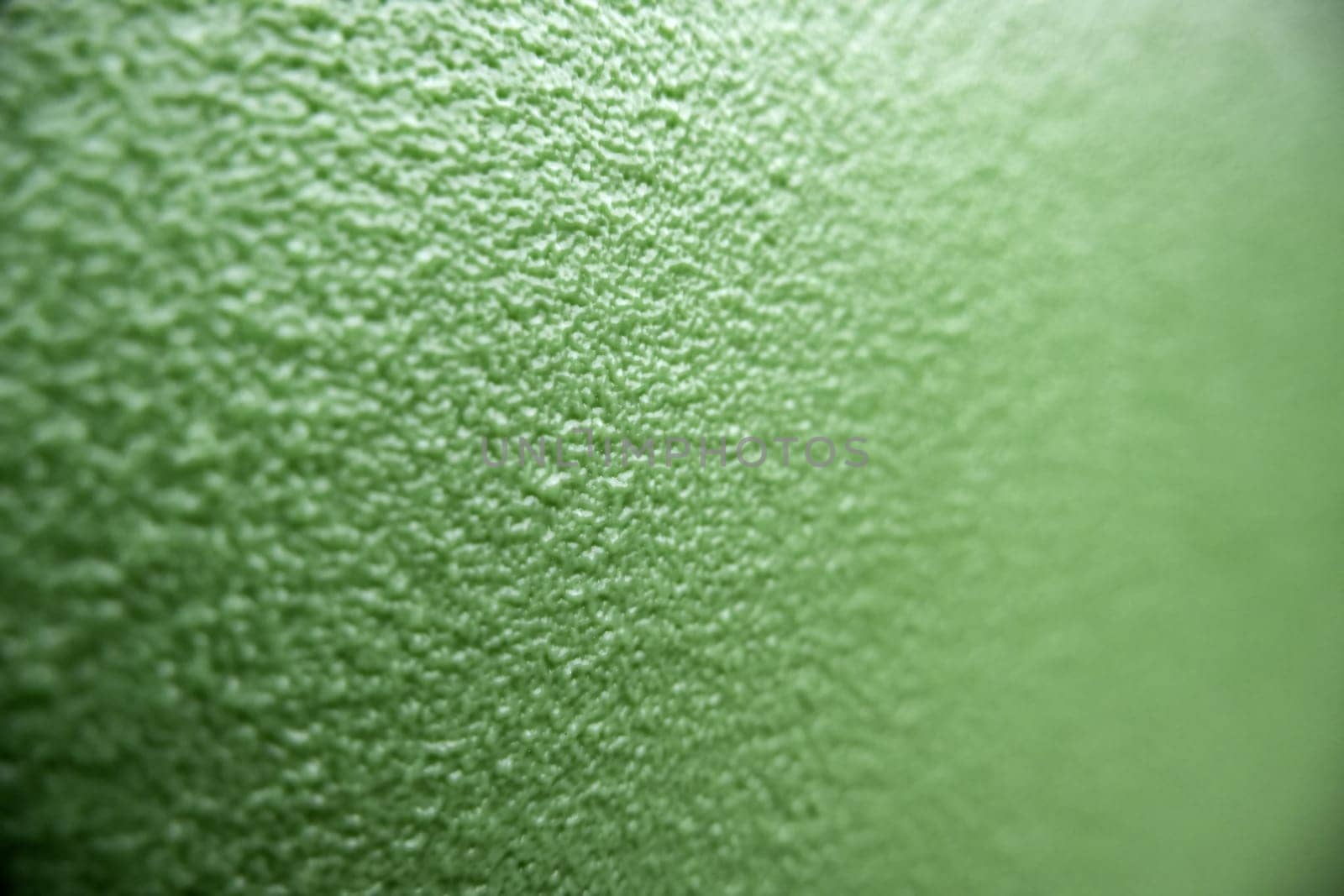 Detail of green rough background with texture, decorated wall