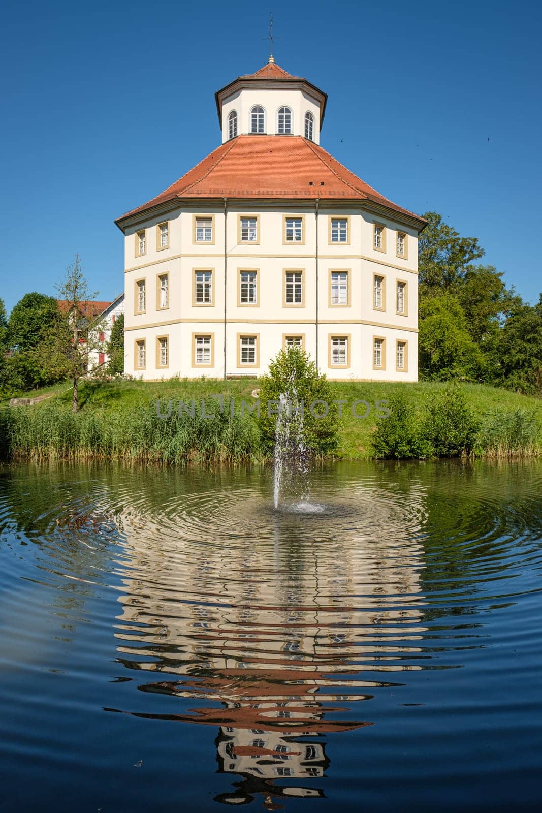 City hall in former water castle of Oppenweiler with lake and fontain