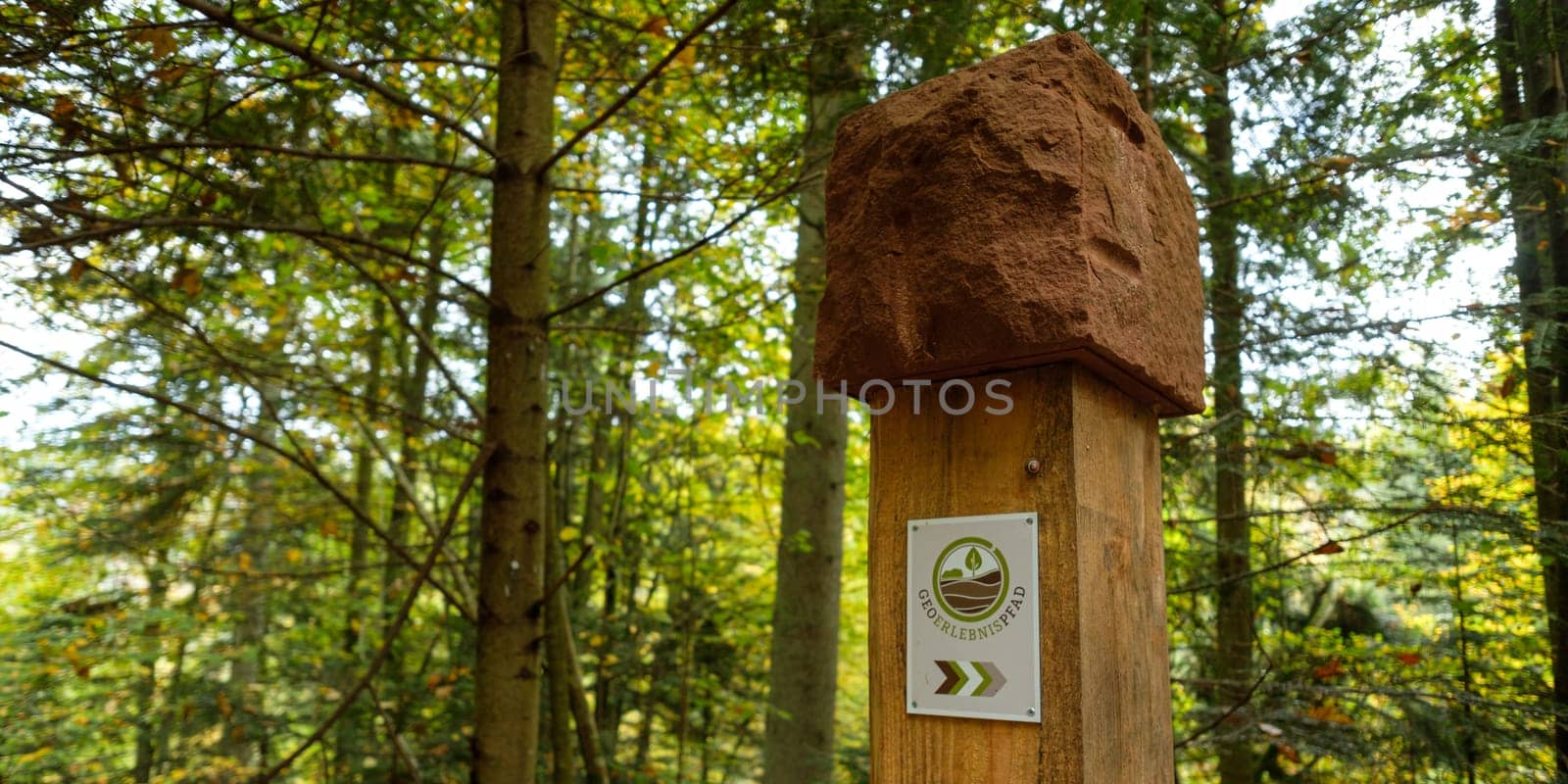 Sign of geology path in german forest landscape