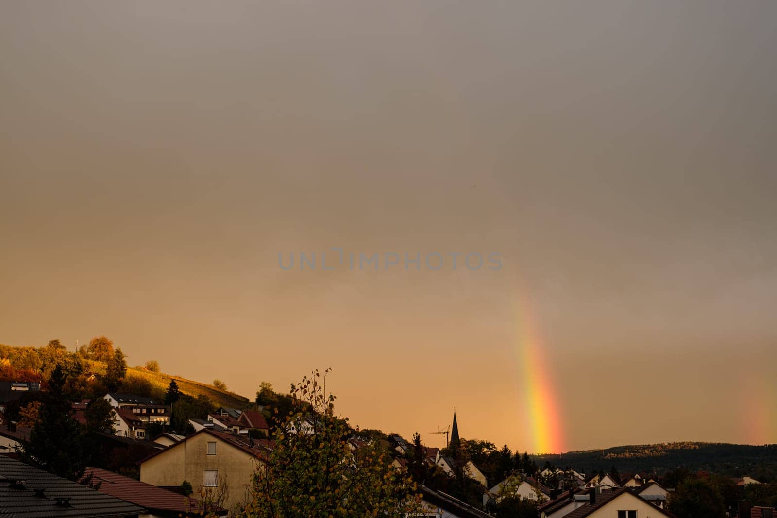 Rainbow in summer over houses sky