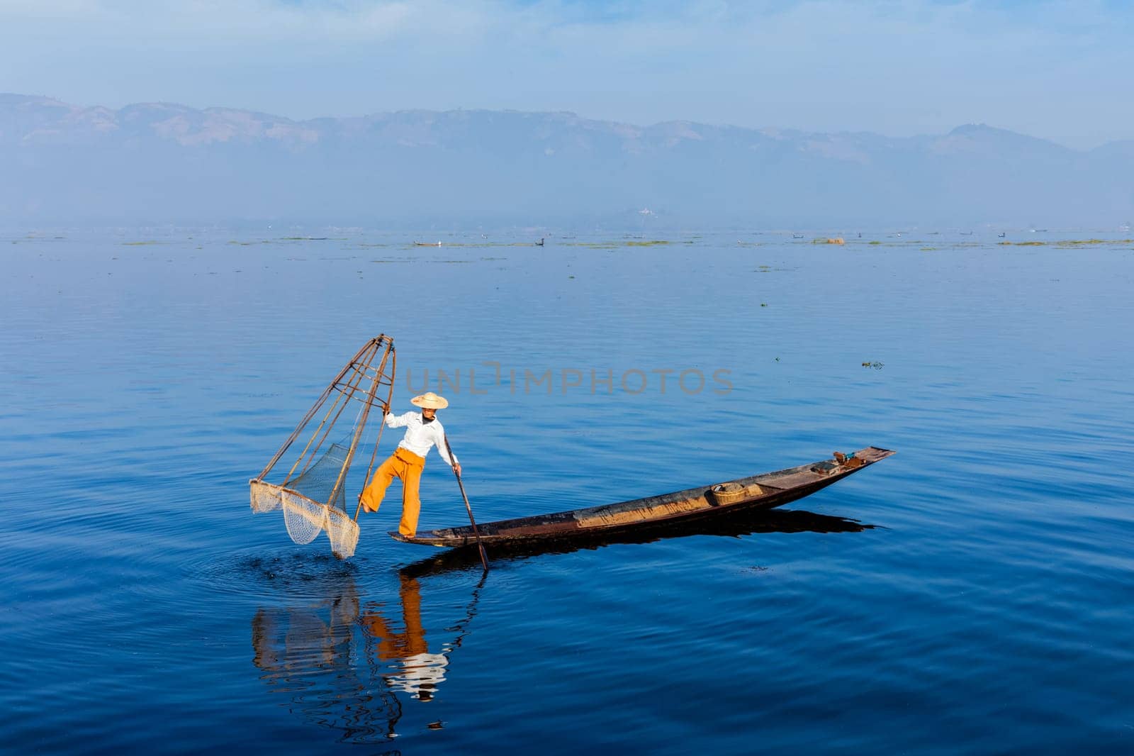 Myanmar travel attraction landmark - Traditional Burmese fisherman at Inle lake, Myanmar famous for their distinctive one legged rowing style