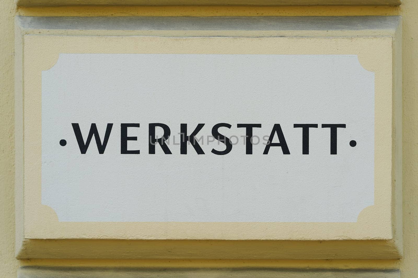 German inscription Werkstatt on the facade of a craft business in Berlin. Translation: Workshop