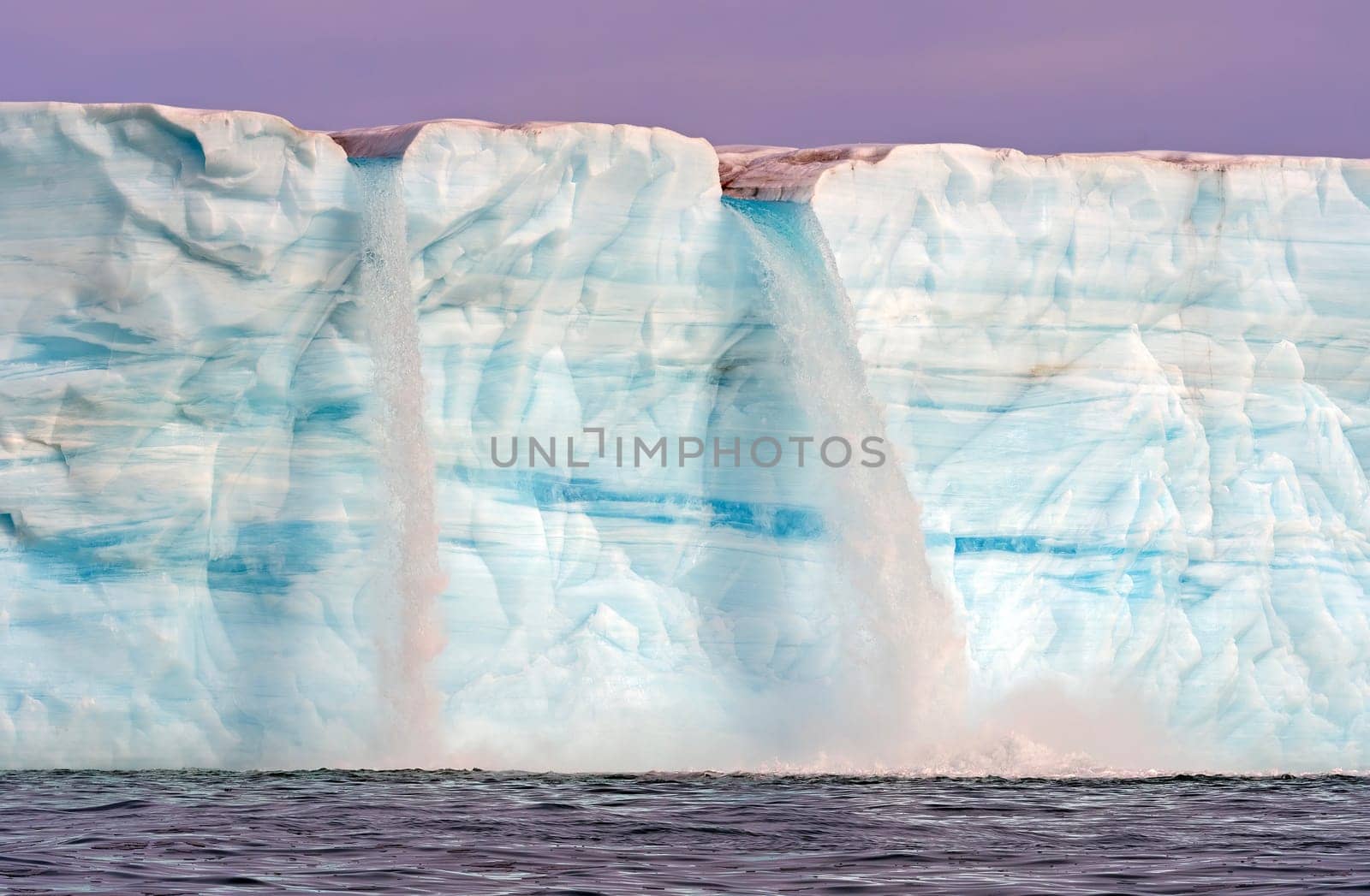 Twin Waterfalls on a Melting Tidal Glacier on Nordaustlandet Island in the Svalbard Islands