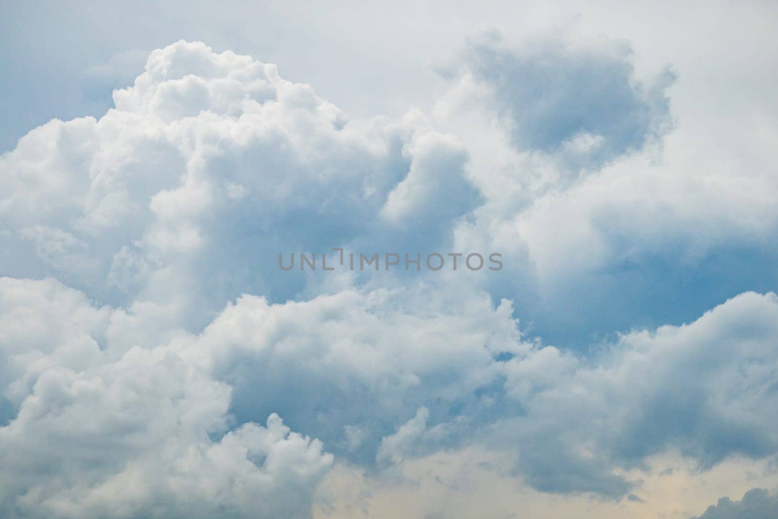 Grey blue sky with white fluffy clouds, natural photography background taken in France
