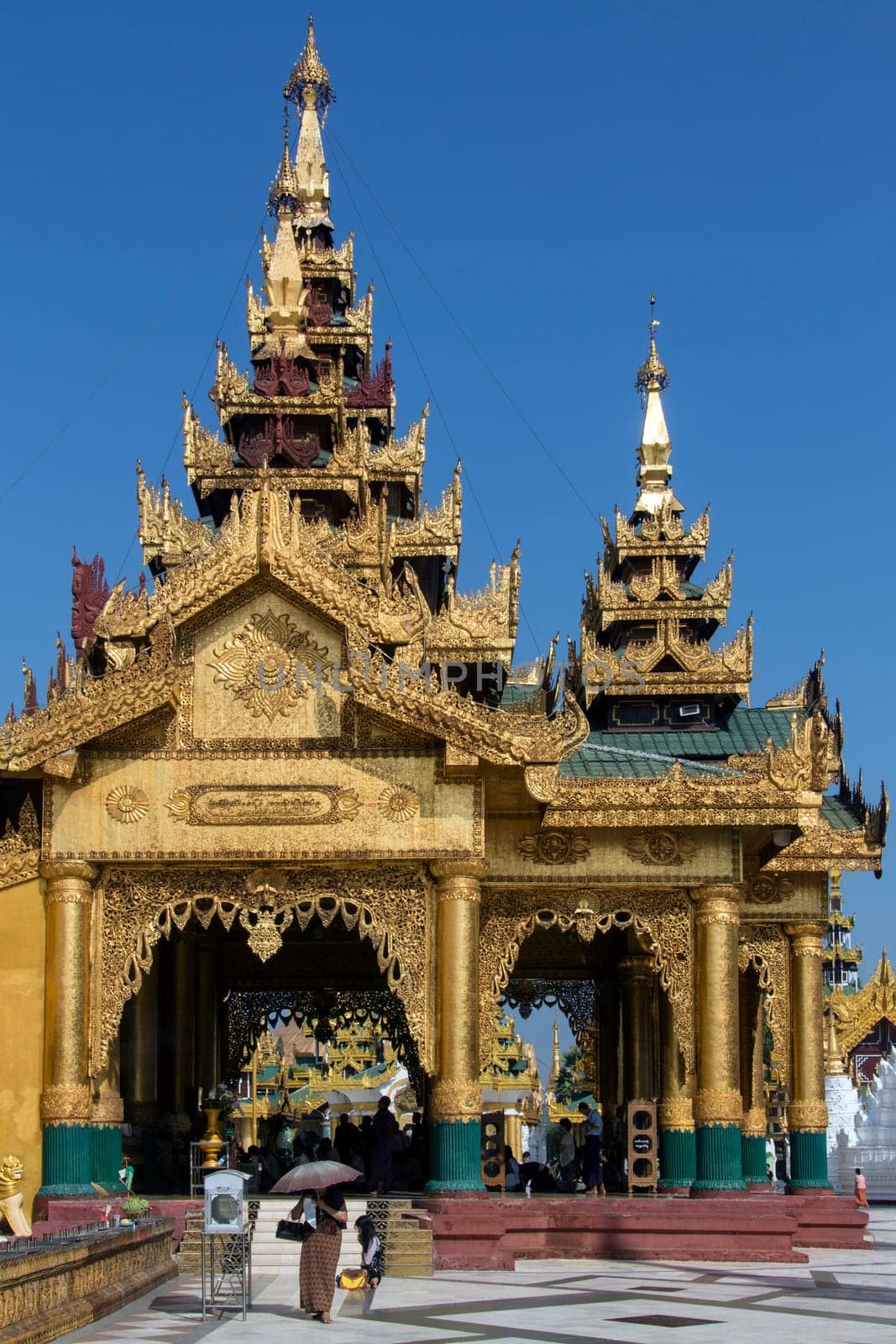 Temples in the Shwedagon Pagoda complex in the city of Yangon in Myanmar (Burma). The Shwedagon Pagoda, officially titled Shwedagon Zedi Daw, is a 99m (325ft) gilded pagoda and stupa. The complex contains hundreds of other Buddhist stupa, temples and shrines.