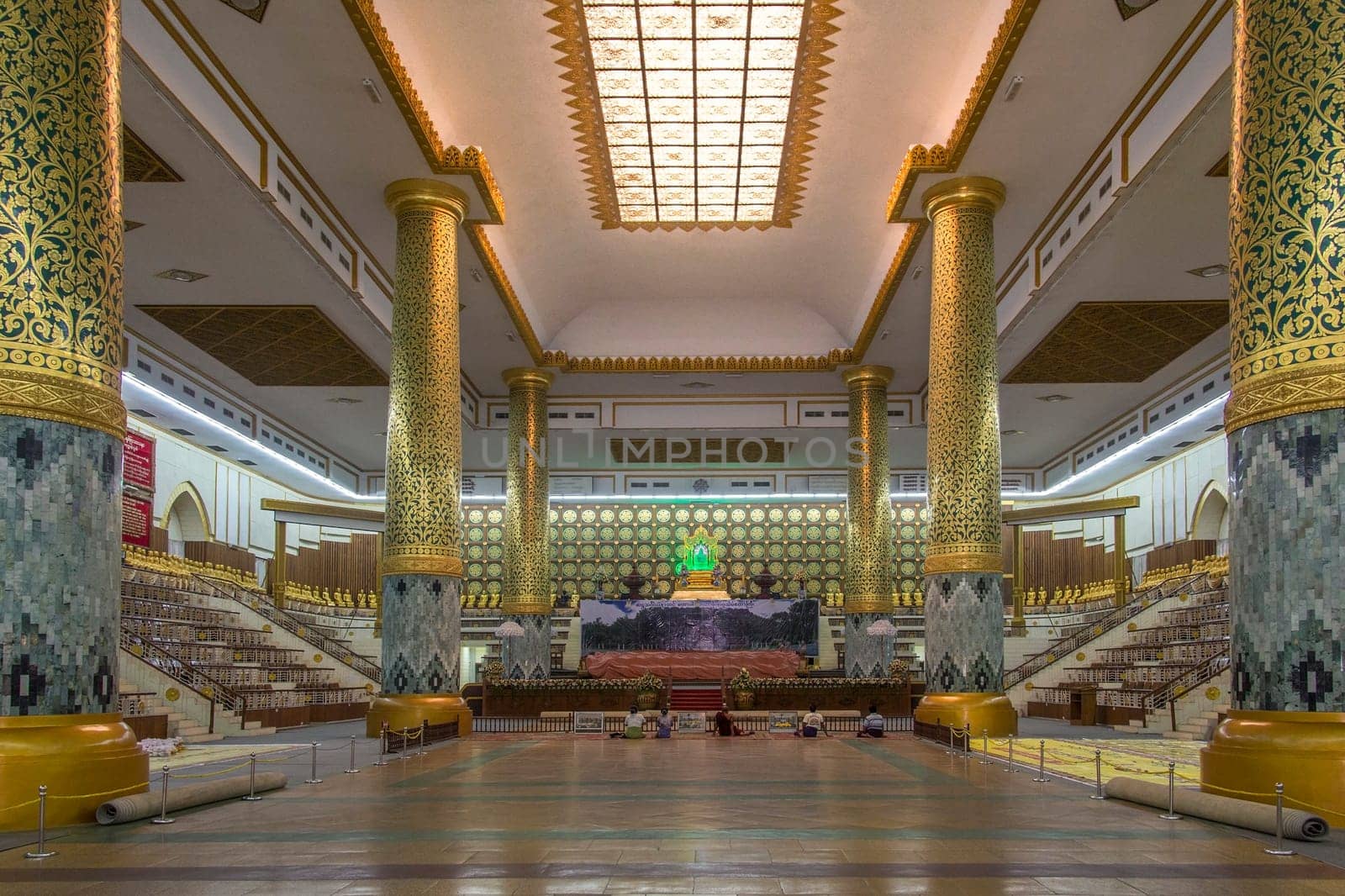 Interior of the Mahapasana Guha Cave and Buddhist Ordination Hall in Yangon, Myanmar. It is adjacent to the Kaba Aye Pagoda. Here, religious examination called the Tipitakadhara Tipitaka Kovida Examinations take place, an extensive recitation, oral and written examination on the Tipitaka, the religious body of works in Theravada Buddhism.