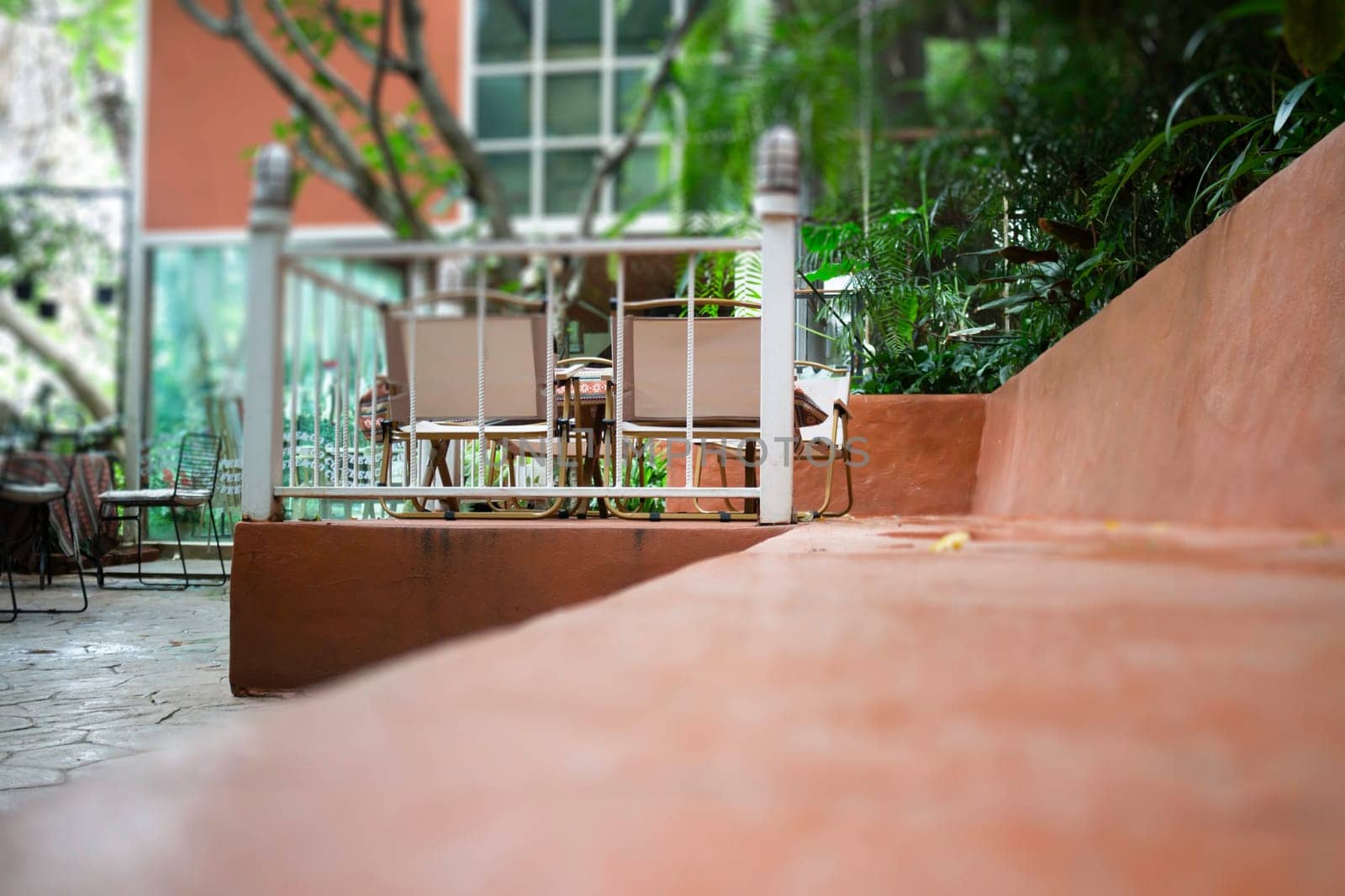 A coffee shop terrace with tables and chairs, stock photo