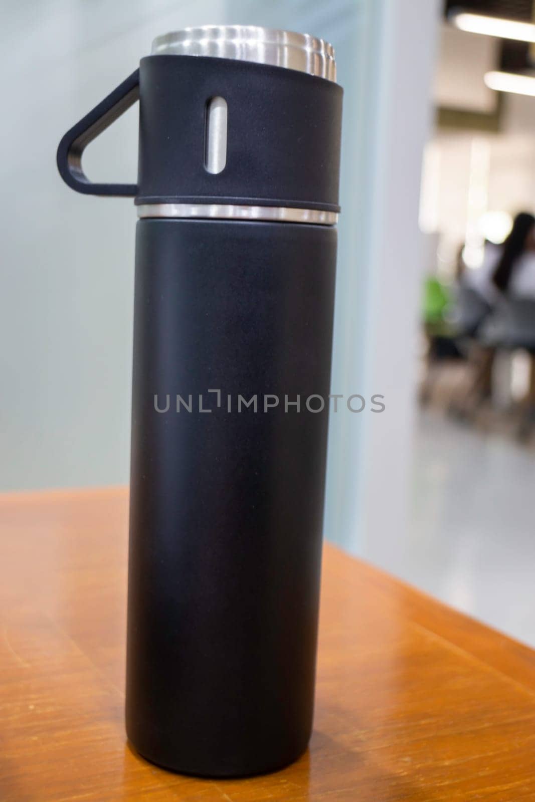 Thermos for preservation of a hot or cold drink water bottle, stock photo