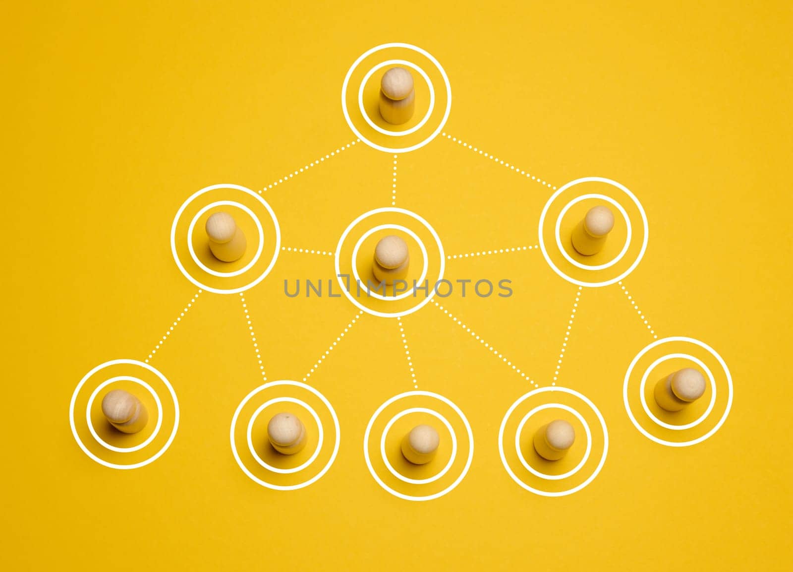 Wooden figures connected by lines, concept of delegation and hierarchy in a company, top view