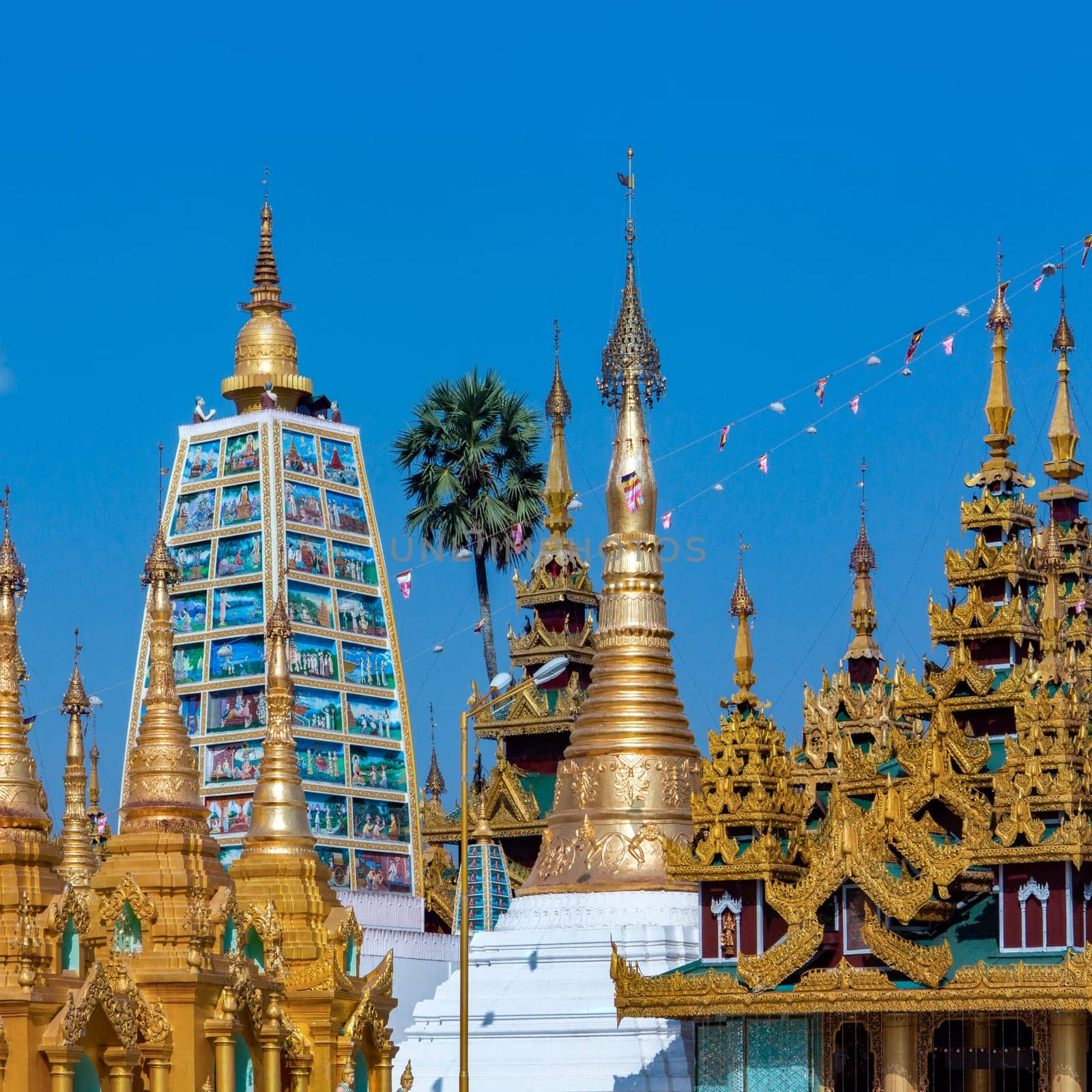 Temples in the Shwedagon Pagoda complex in the city of Yangon in Myanmar (Burma). The Shwedagon Pagoda, officially titled Shwedagon Zedi Daw, is a 99m (325ft) gilded pagoda and stupa. The complex contains hundreds of other Buddhist stupa, temples and shrines.