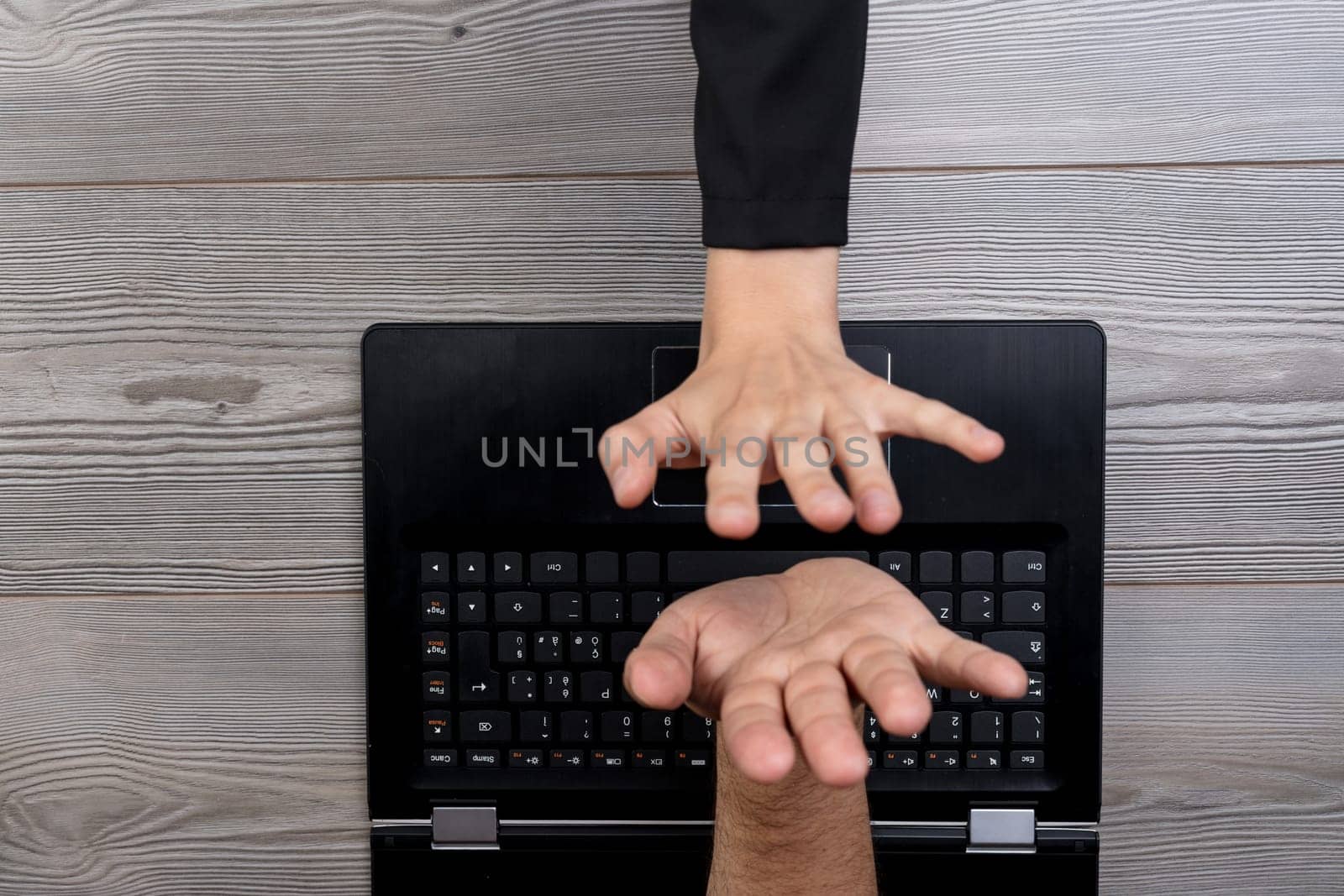hand emerges from a laptop screen to high-five a user, symbolizing the interactive and connective power of technology. This image highlights the blending of virtual and physical interactions