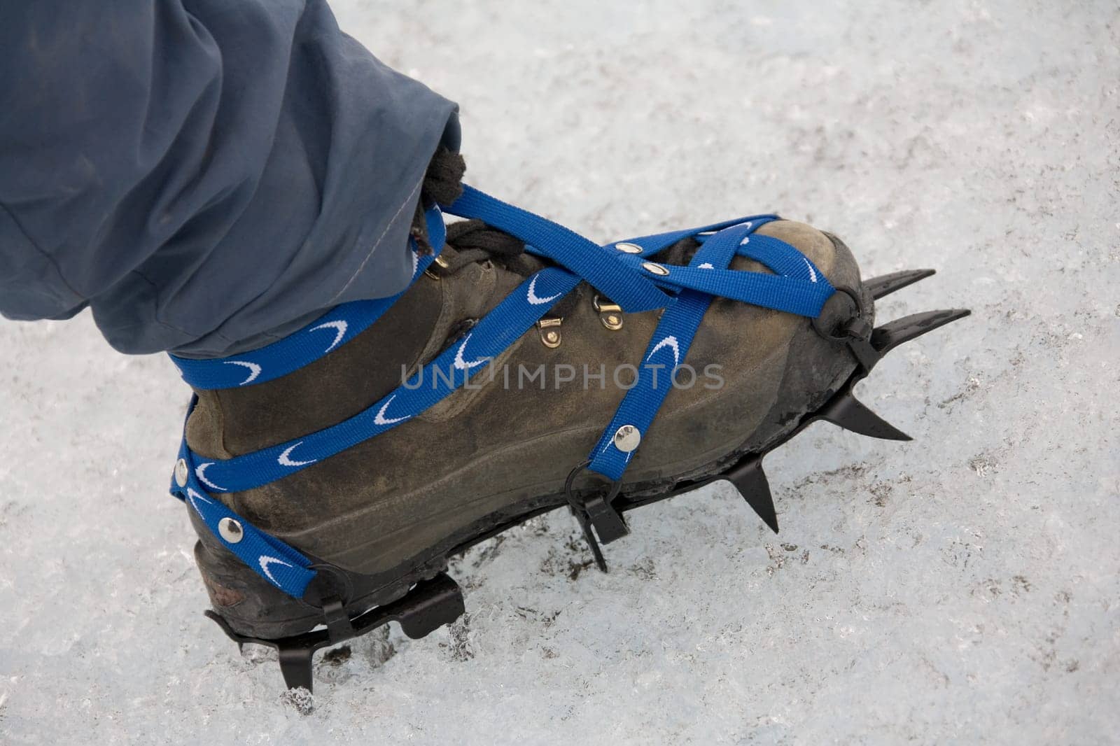 Ice climber wearing crampons on the Perito Moreno Glacier in Patagonia in southern Argentina, South America.
