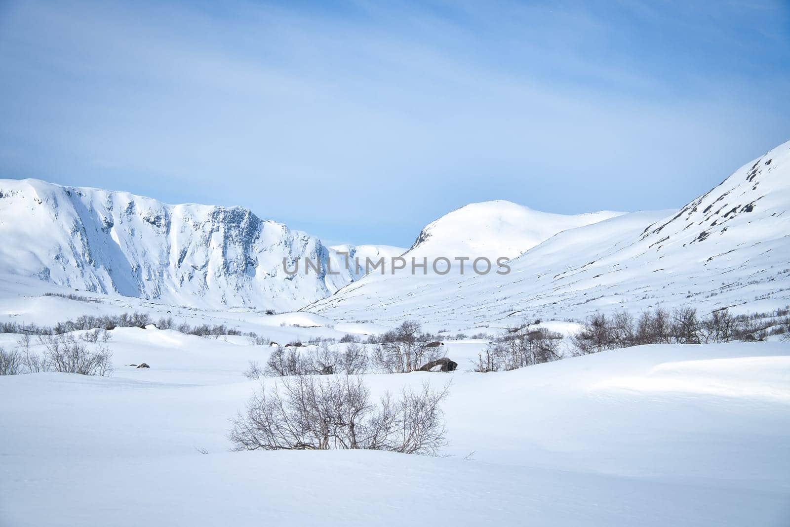 Norwegian high mountains in the snow. Mountains covered in snow. Scandinavian landscape in the far north