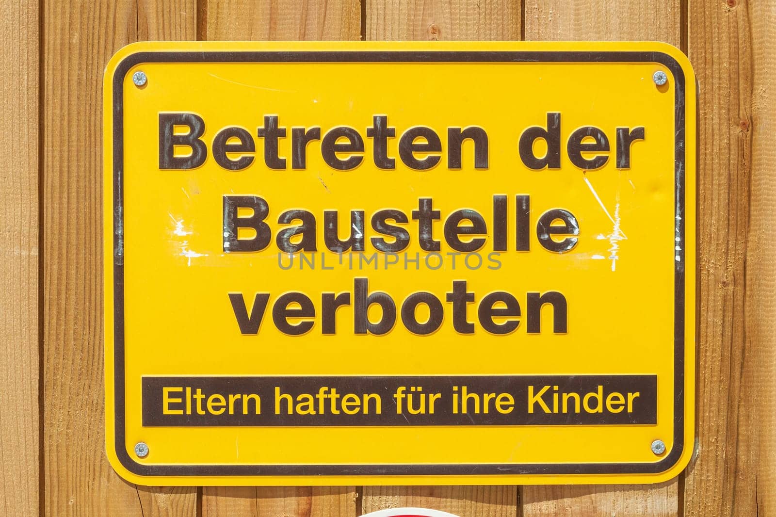 Yellow sign No trespassing on a construction site, Germany