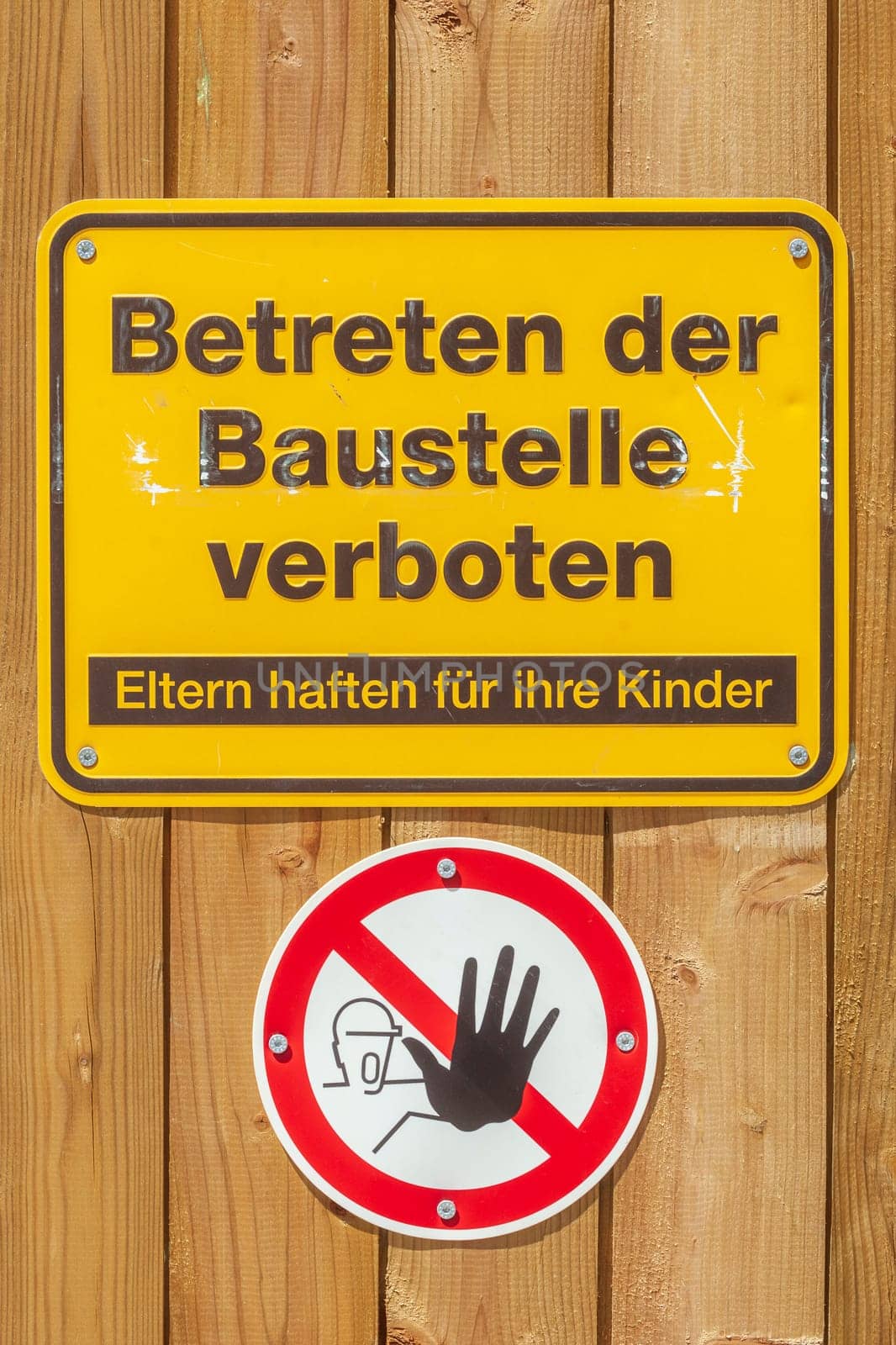 Yellow sign No trespassing on a construction site, Germany