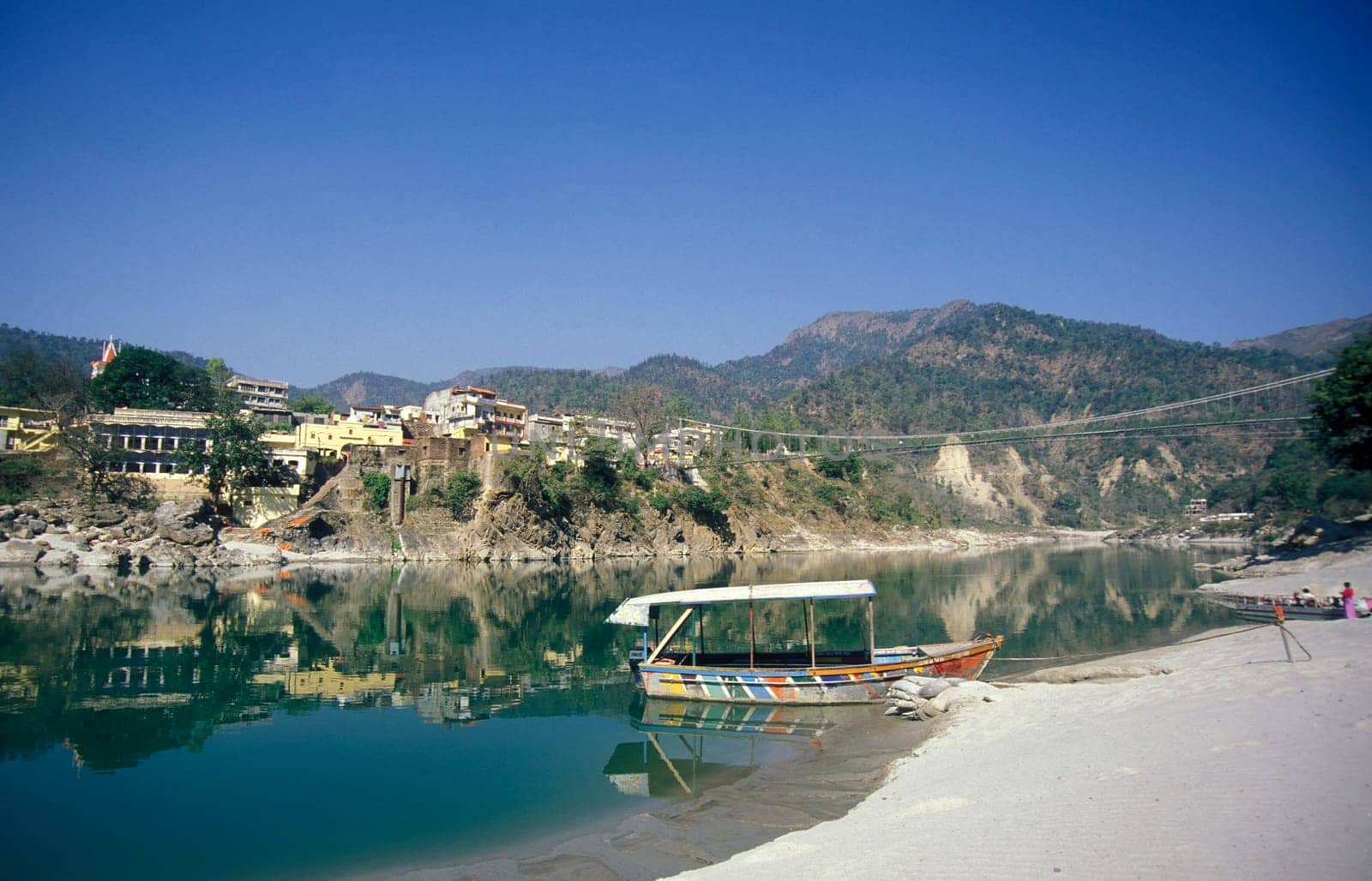 the Holy Ganges River with the city of Rishikesh in the Province Uttarakhand in India.  India, Rishikesh, February, 1998
