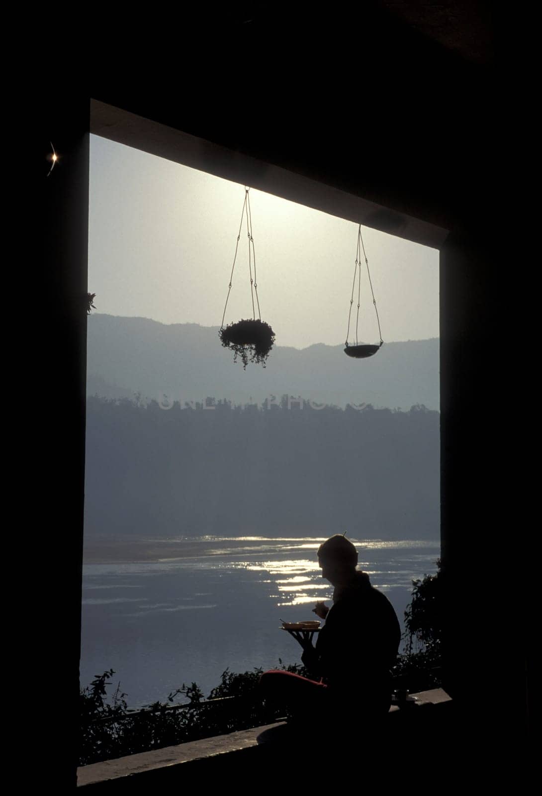 People at a Yoga cless at the Holy Ganges River in the city of Rishikesh in the Province Uttarakhand in India.  India, Rishikesh, February, 1998