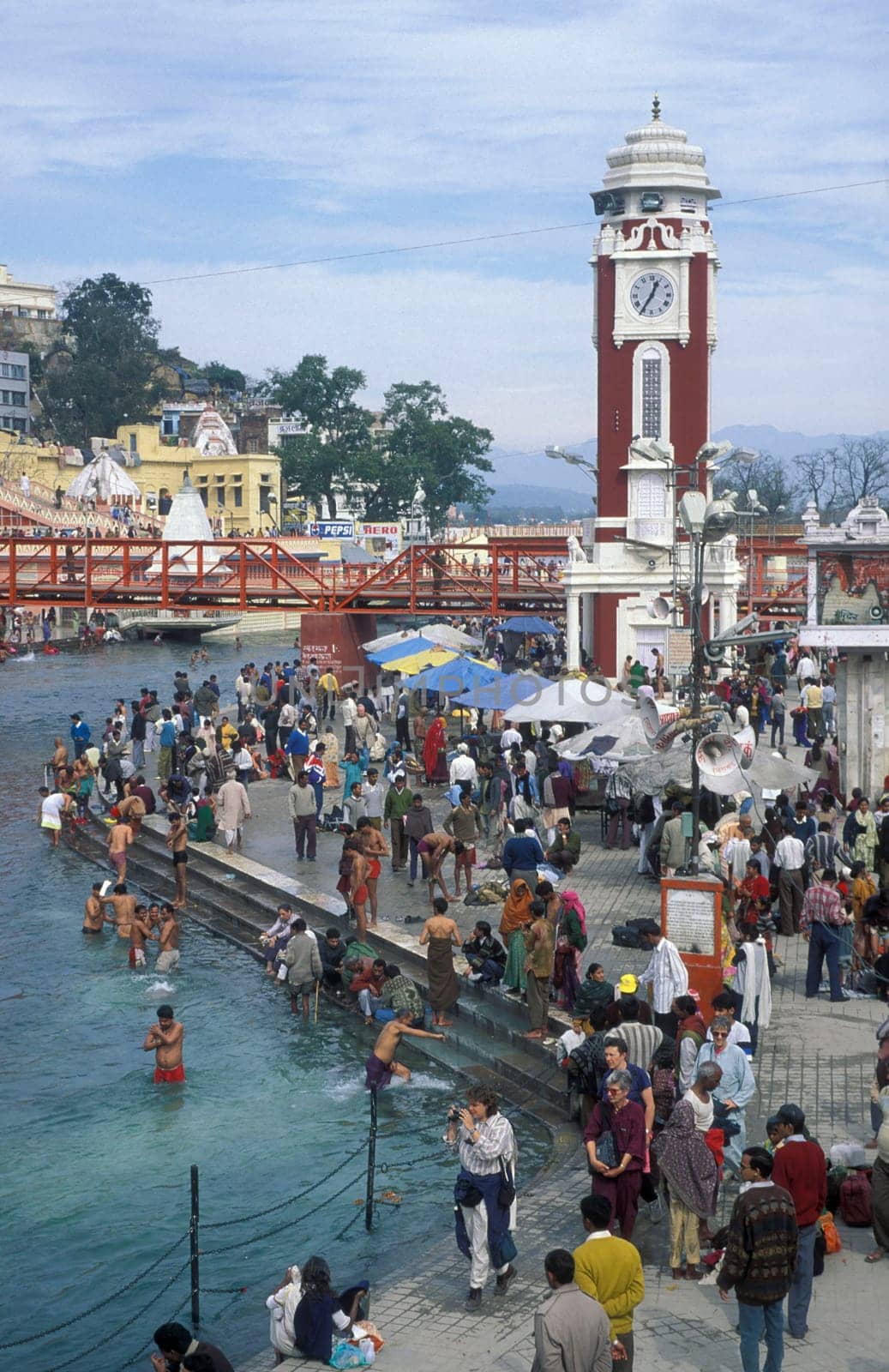 a view over public aerea with the Clock Tower at the Holy Ganges River in the city of Haridwar in the Province Uttarakhand in India.  India, Haridwar, February, 1998