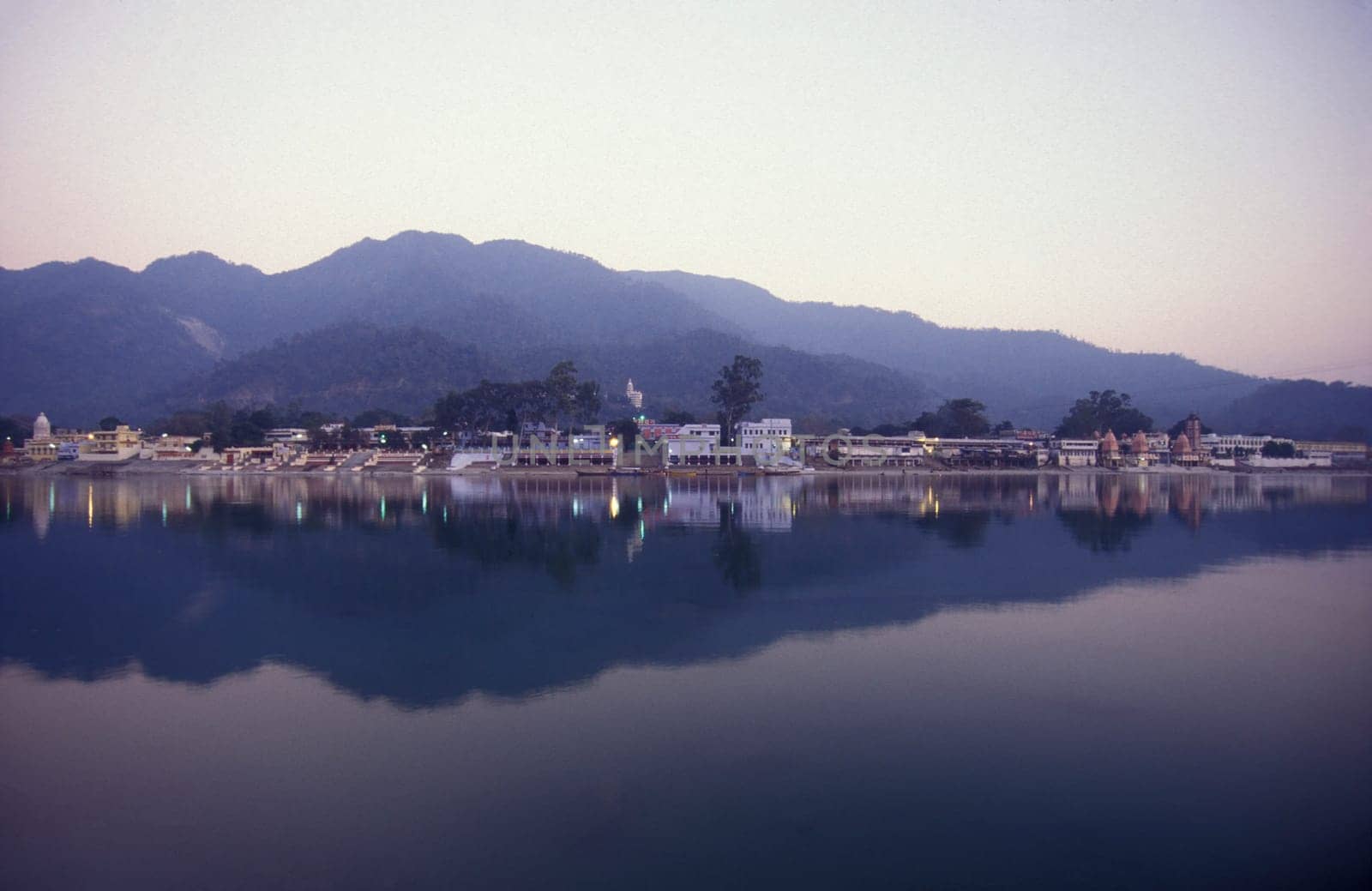 the Holy Ganges River with the city of Rishikesh in the Province Uttarakhand in India.  India, Rishikesh, February, 1998