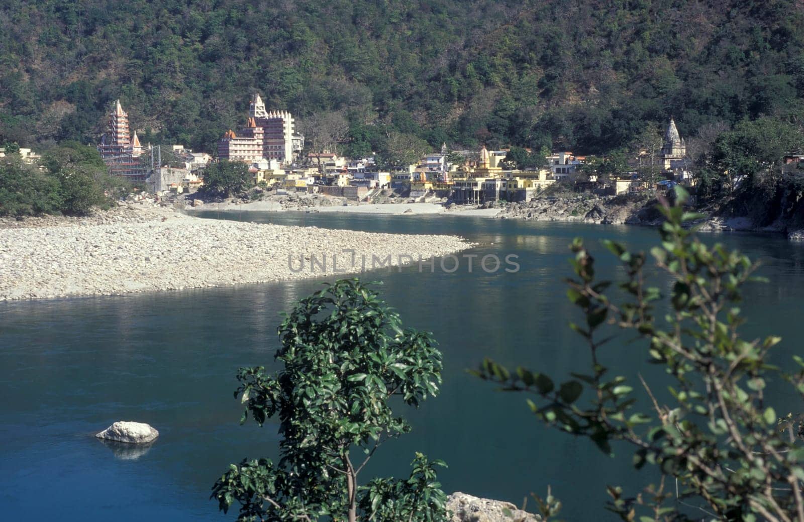 the Holy Ganges River with the city of Rishikesh in the Province Uttarakhand in India.  India, Rishikesh, February, 1998