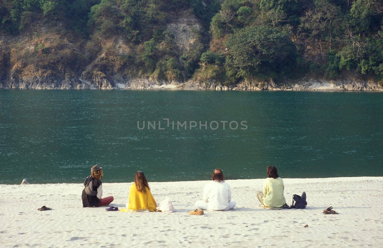 People at a Yoga class at the Holy Ganges River in the city of Rishikesh in the Province Uttarakhand in India.  India, Rishikesh, February, 1998