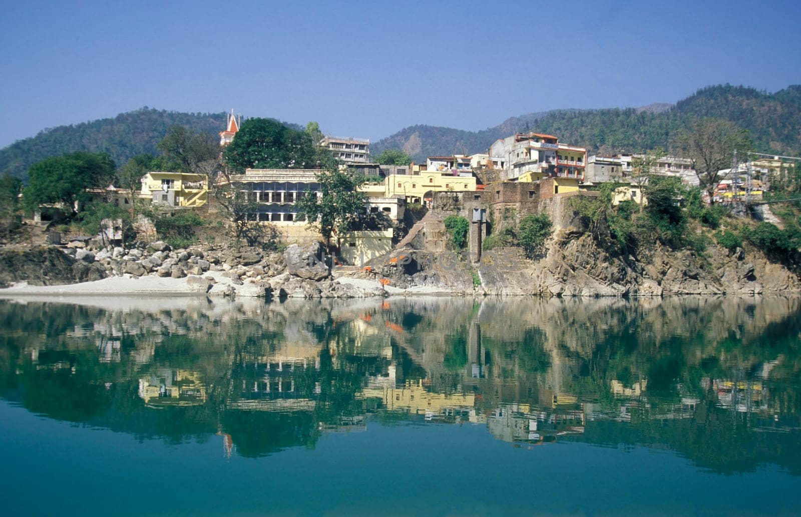 the Holy Ganges River with the city of Rishikesh in the Province Uttarakhand in India.  India, Rishikesh, February, 1998