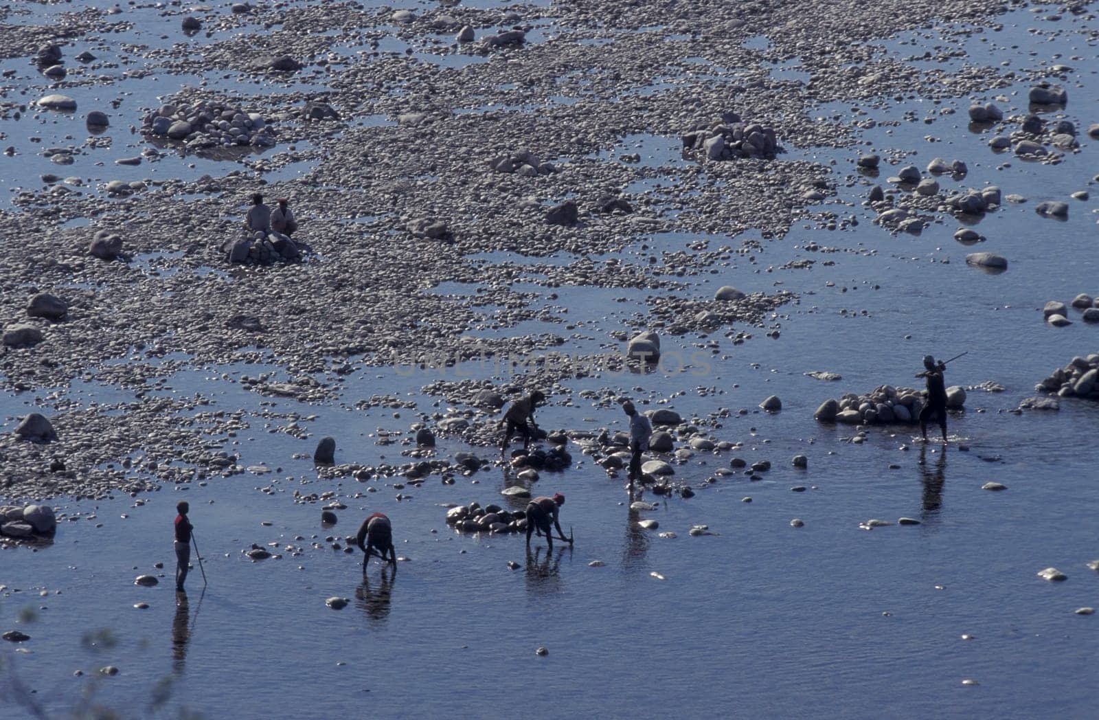 a men and treasure hunter search in the Holy Ganges River in the city of Haridwar in the Province Uttarakhand in India.  India, Haridwar, February, 1998