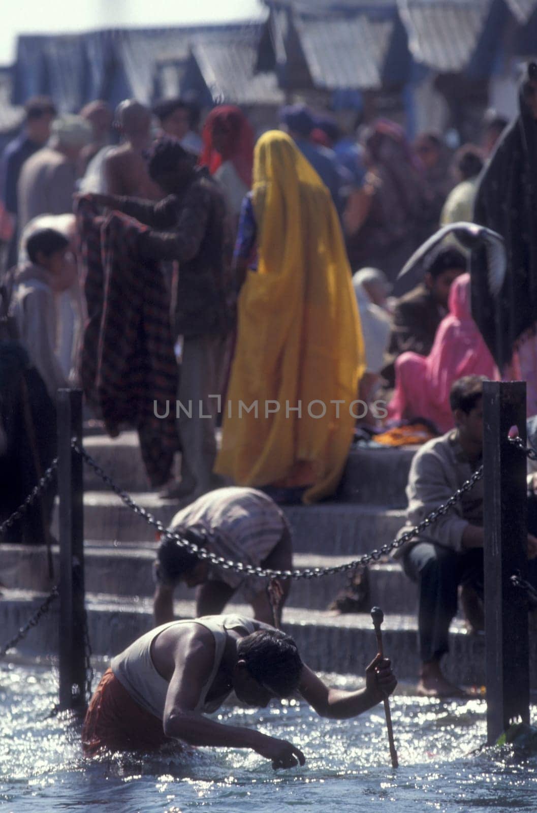 a men and treasure hunter search in the Holy Ganges River in the city of Haridwar in the Province Uttarakhand in India.  India, Haridwar, February, 1998
