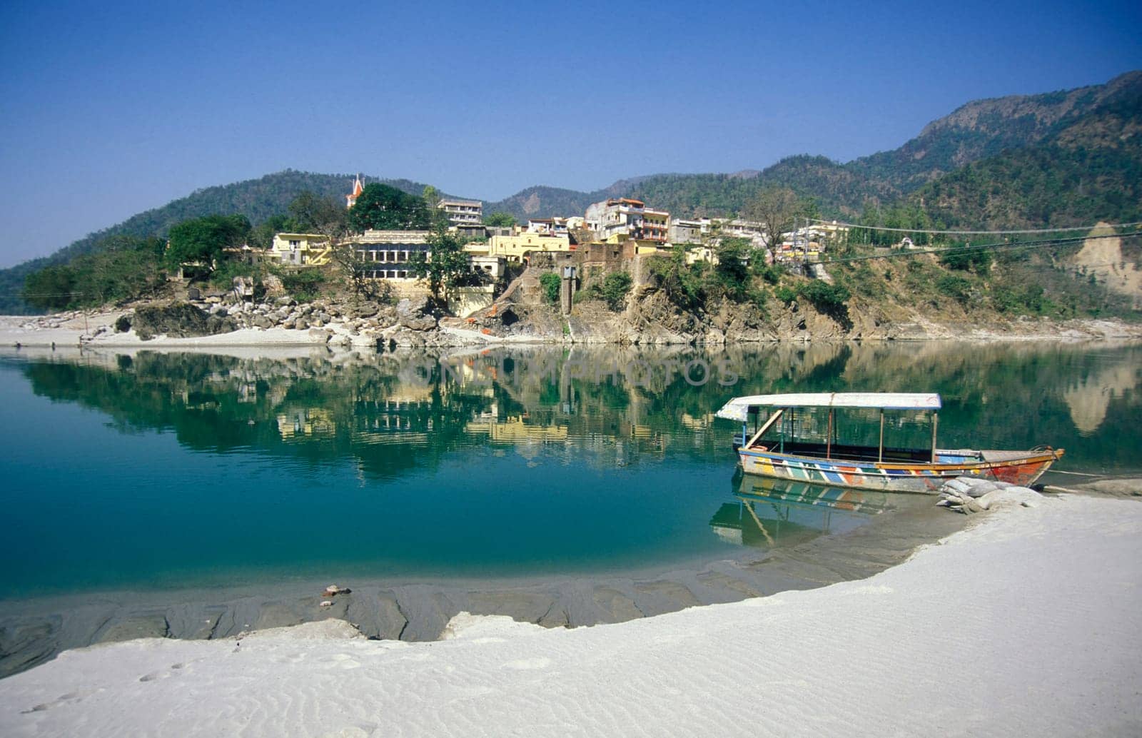 the Holy Ganges River with the city of Rishikesh in the Province Uttarakhand in India.  India, Rishikesh, February, 1998