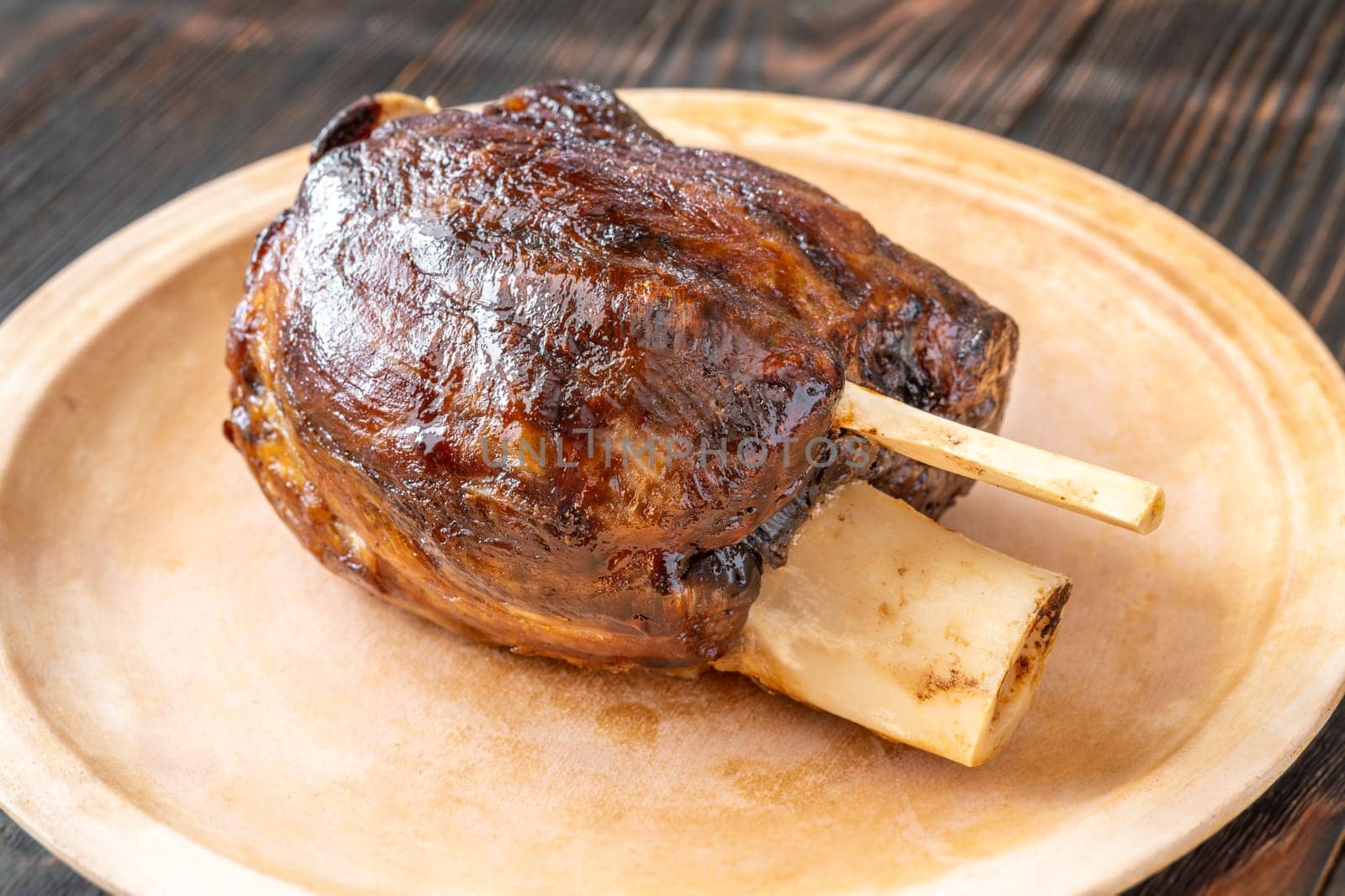 Glazed cooked pork hock on the plate