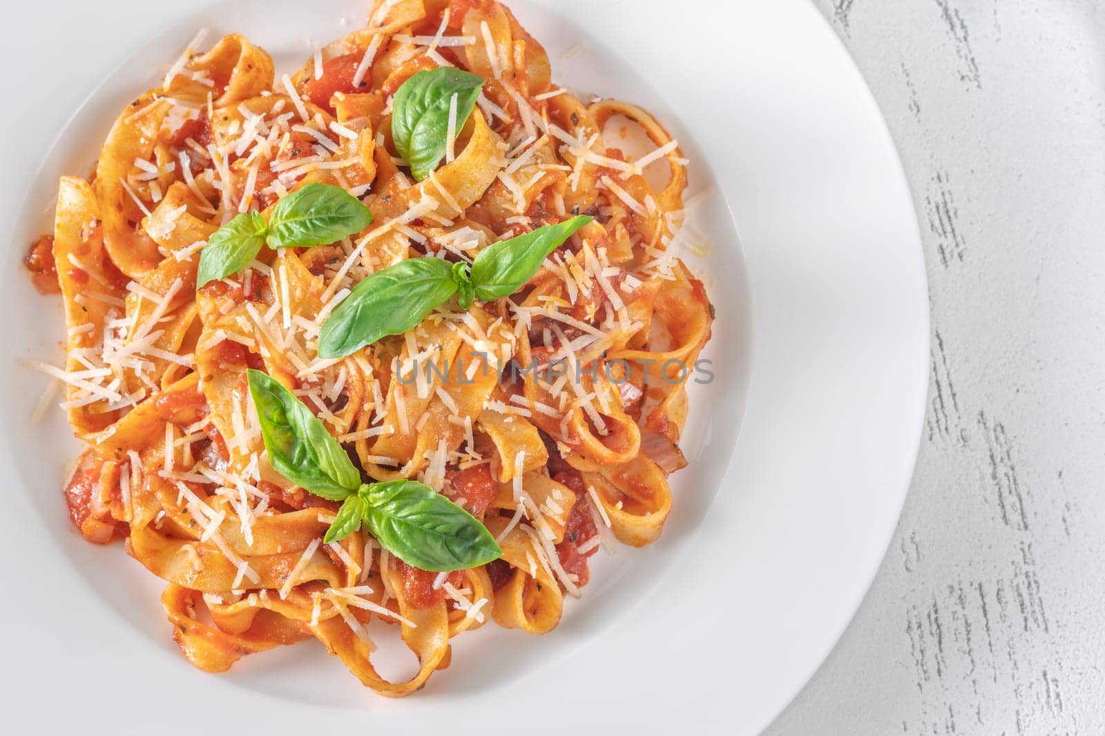 Tagliatelle pasta with tomato sauce and parmesan