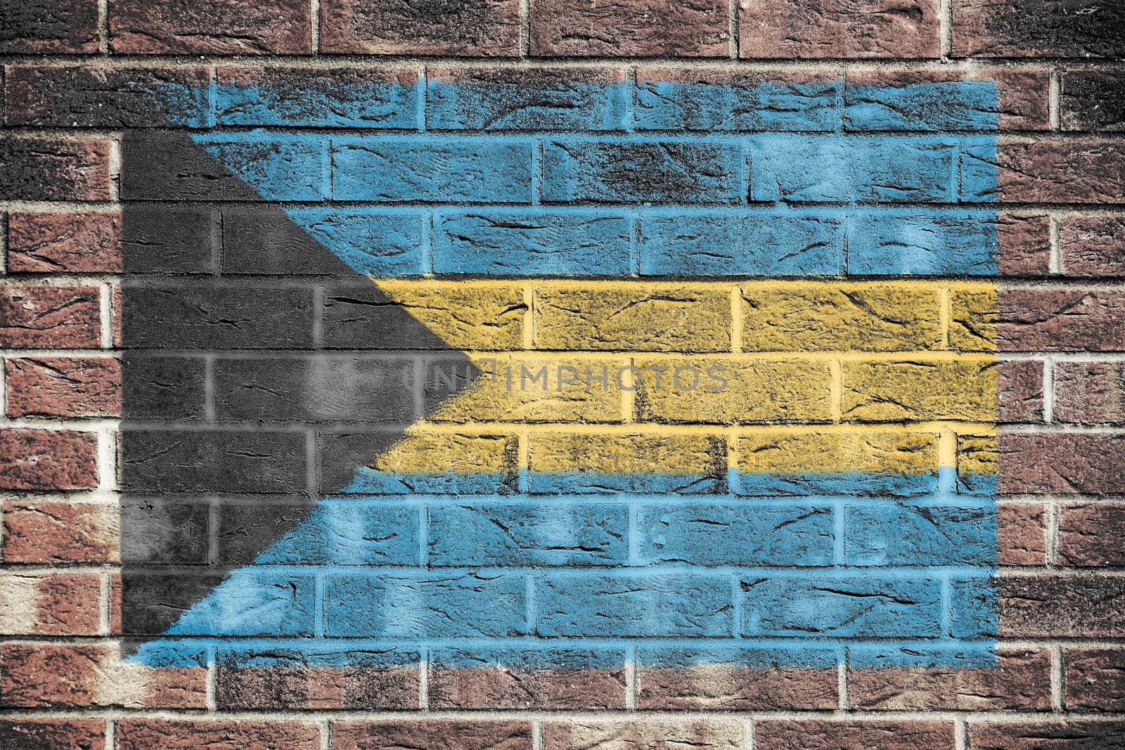 A Bahamas flag on a brick wall background