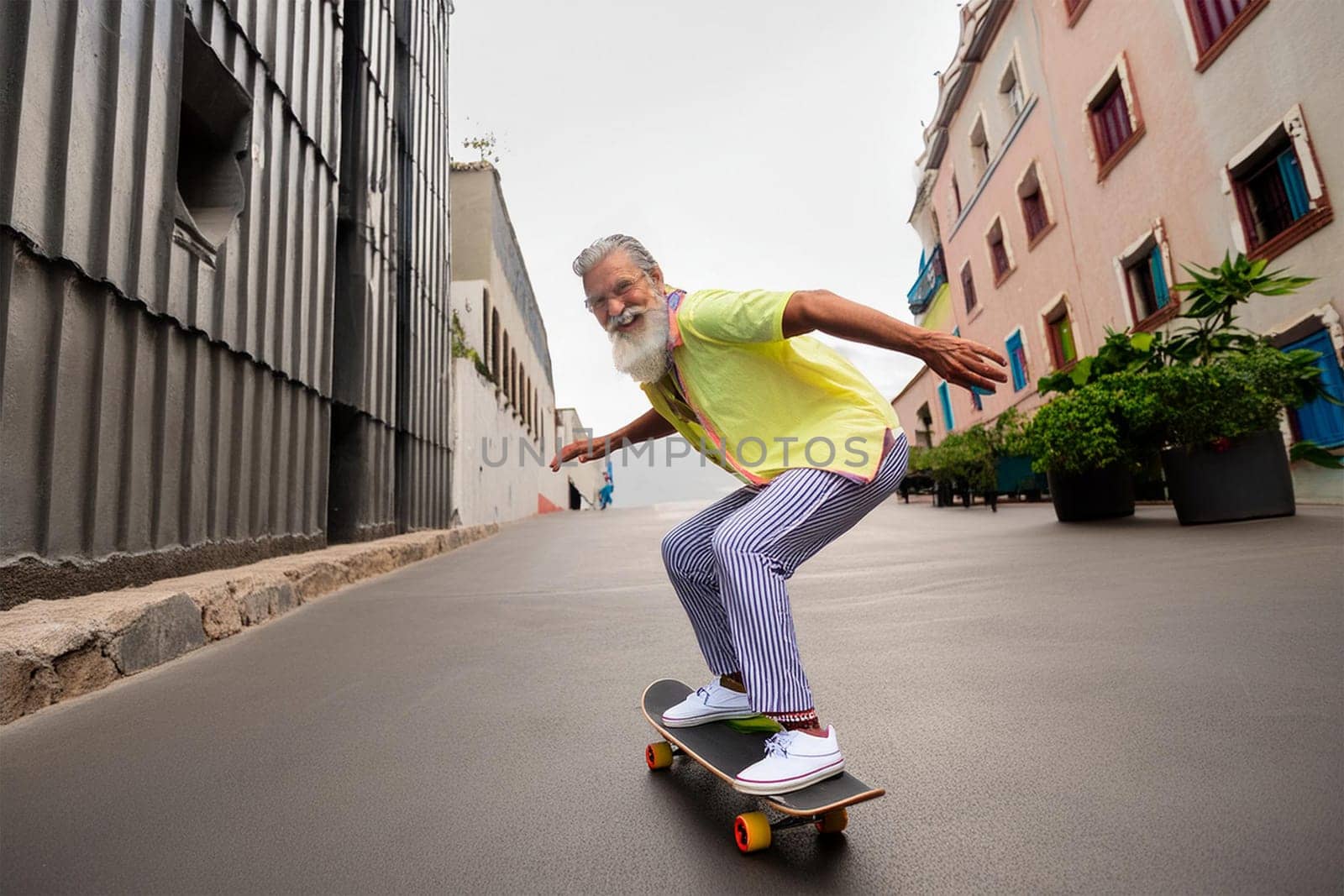 Elderly man in glasses with gray hair and beard skateboarding on urban street, enjoying life.