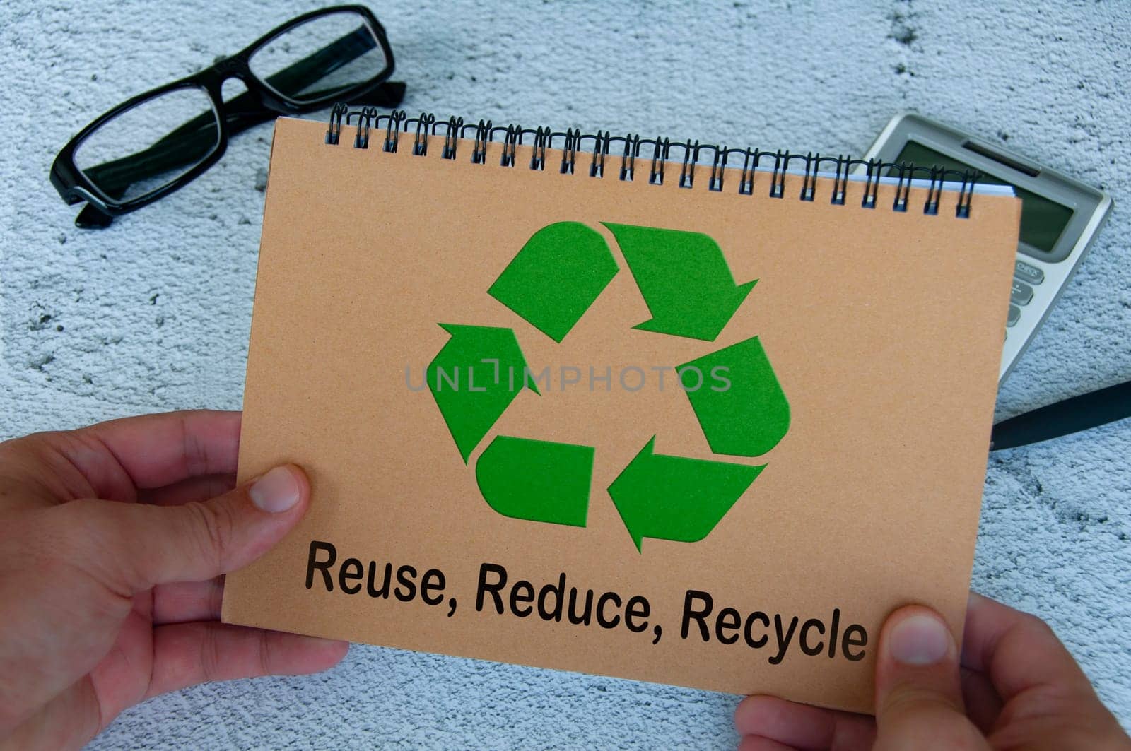 Recycle symbol on brown notebook. Reuse, reduce and recycle.
