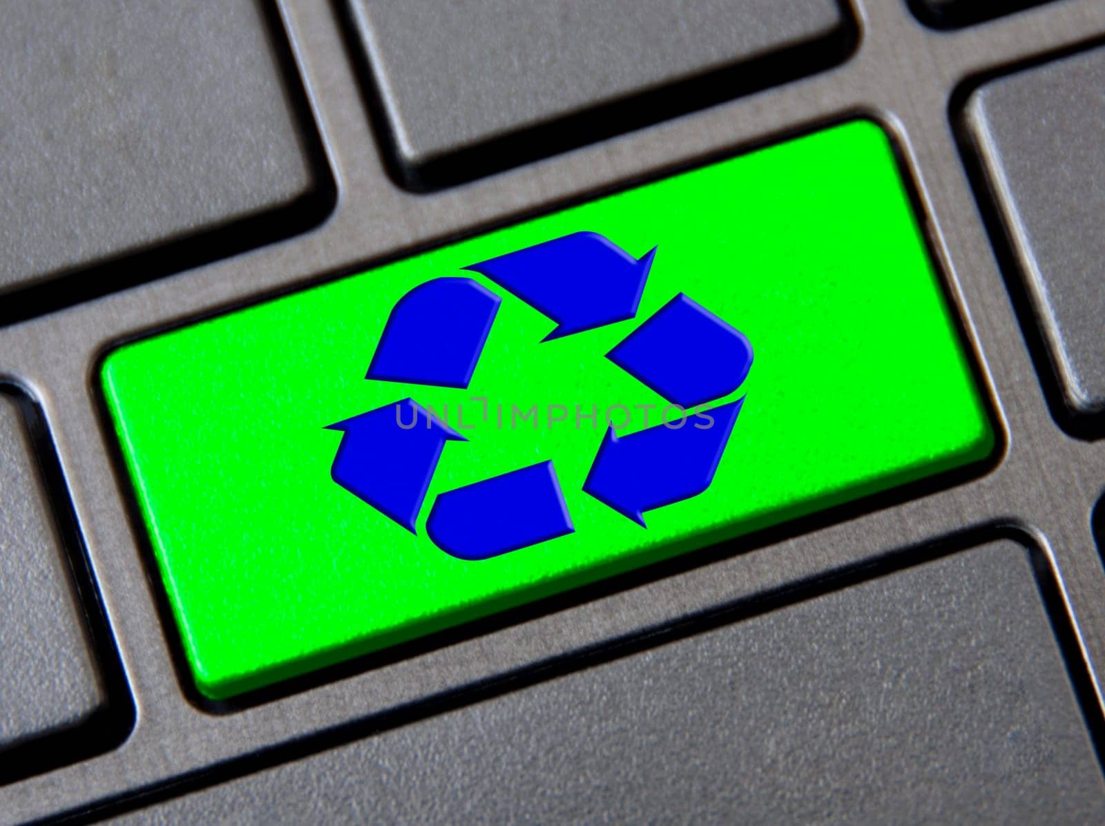Recycle symbol on green keyboard button. Reuse, reduce and recycle.