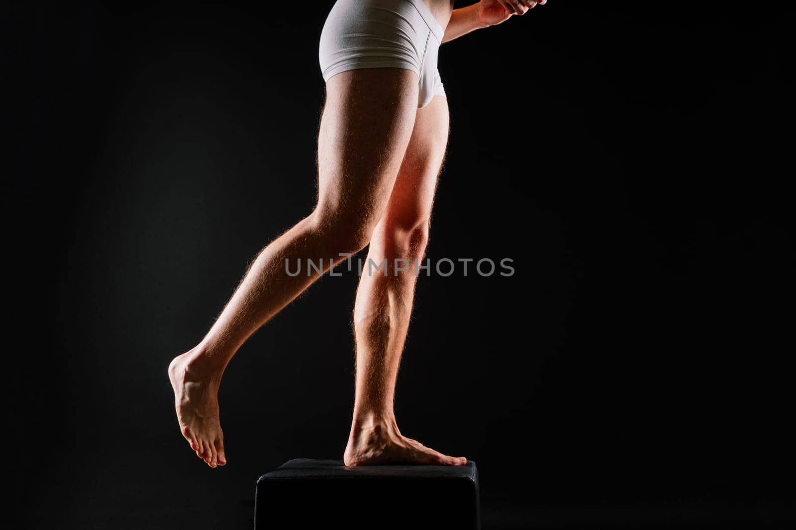 Male muscular legs body-building, muscle man in a white sport panties