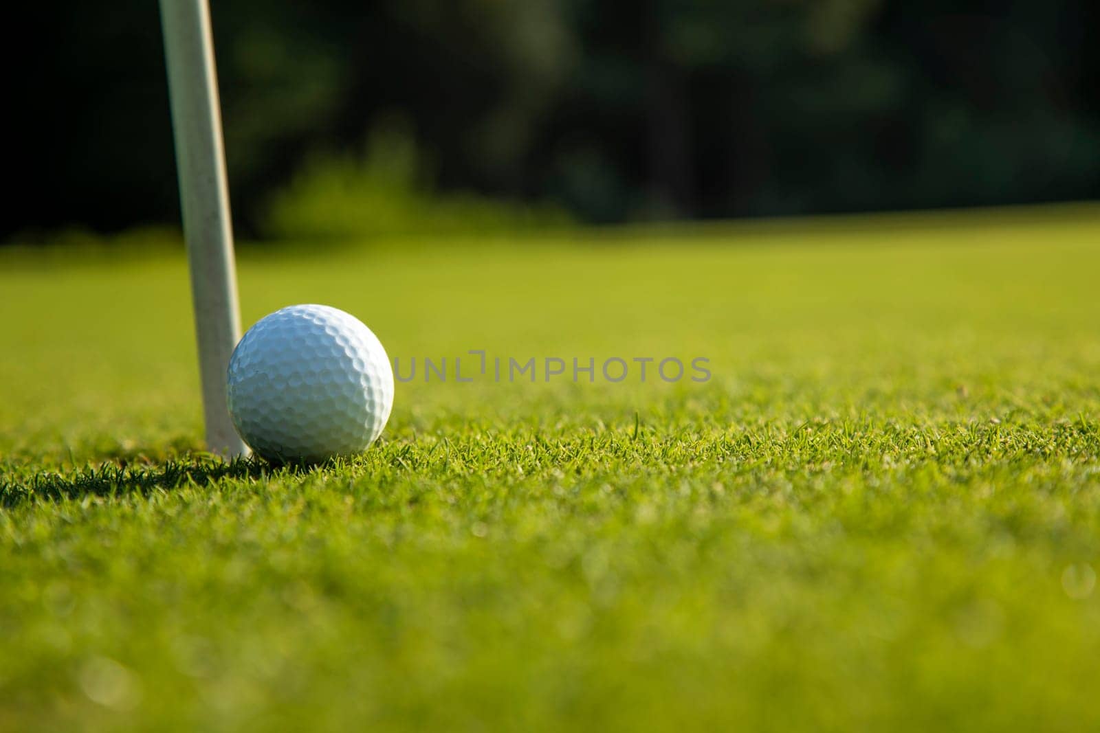 Golf ball and clubs in golf field