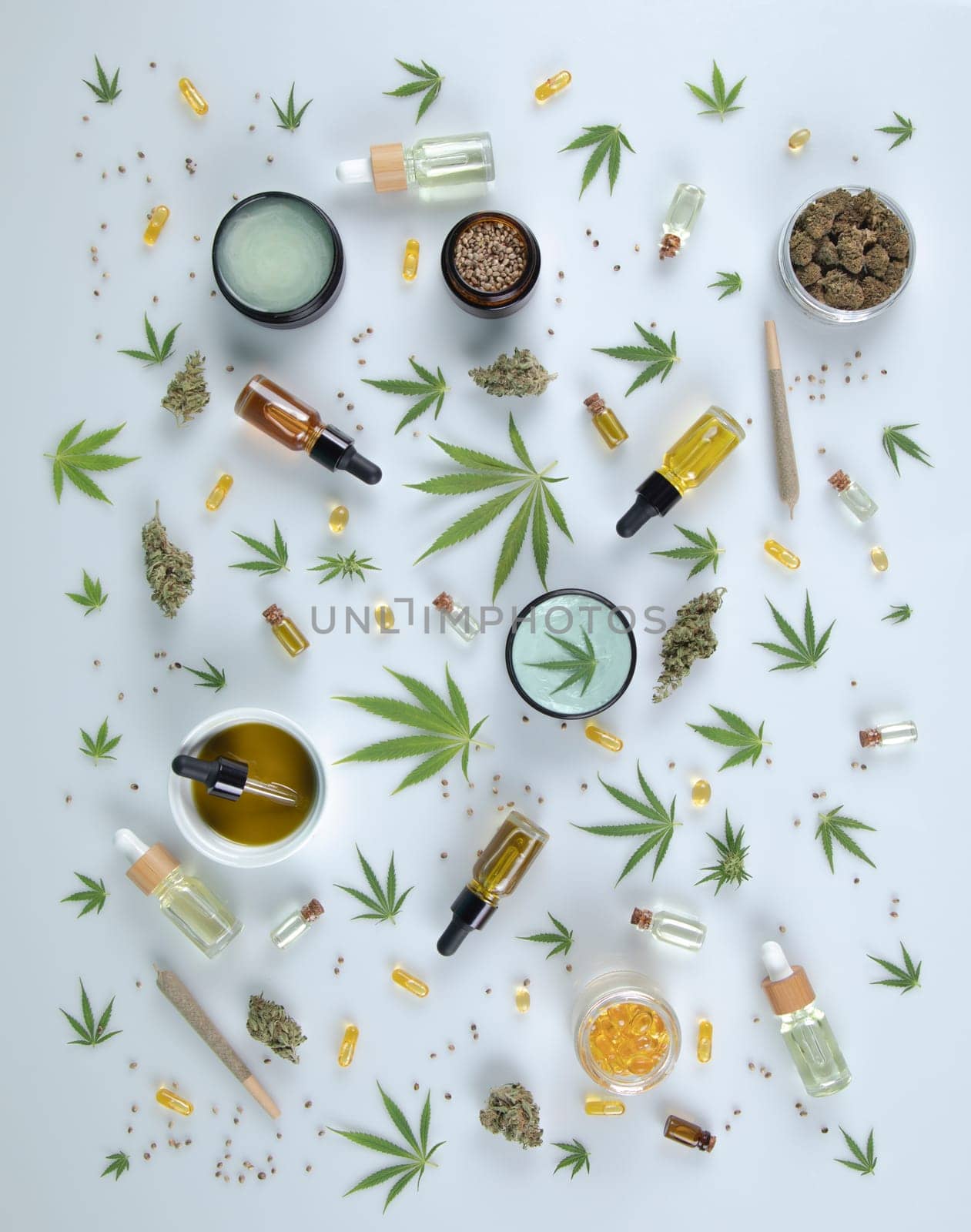 Top view of marijuana leaves and cannabis buds on white background