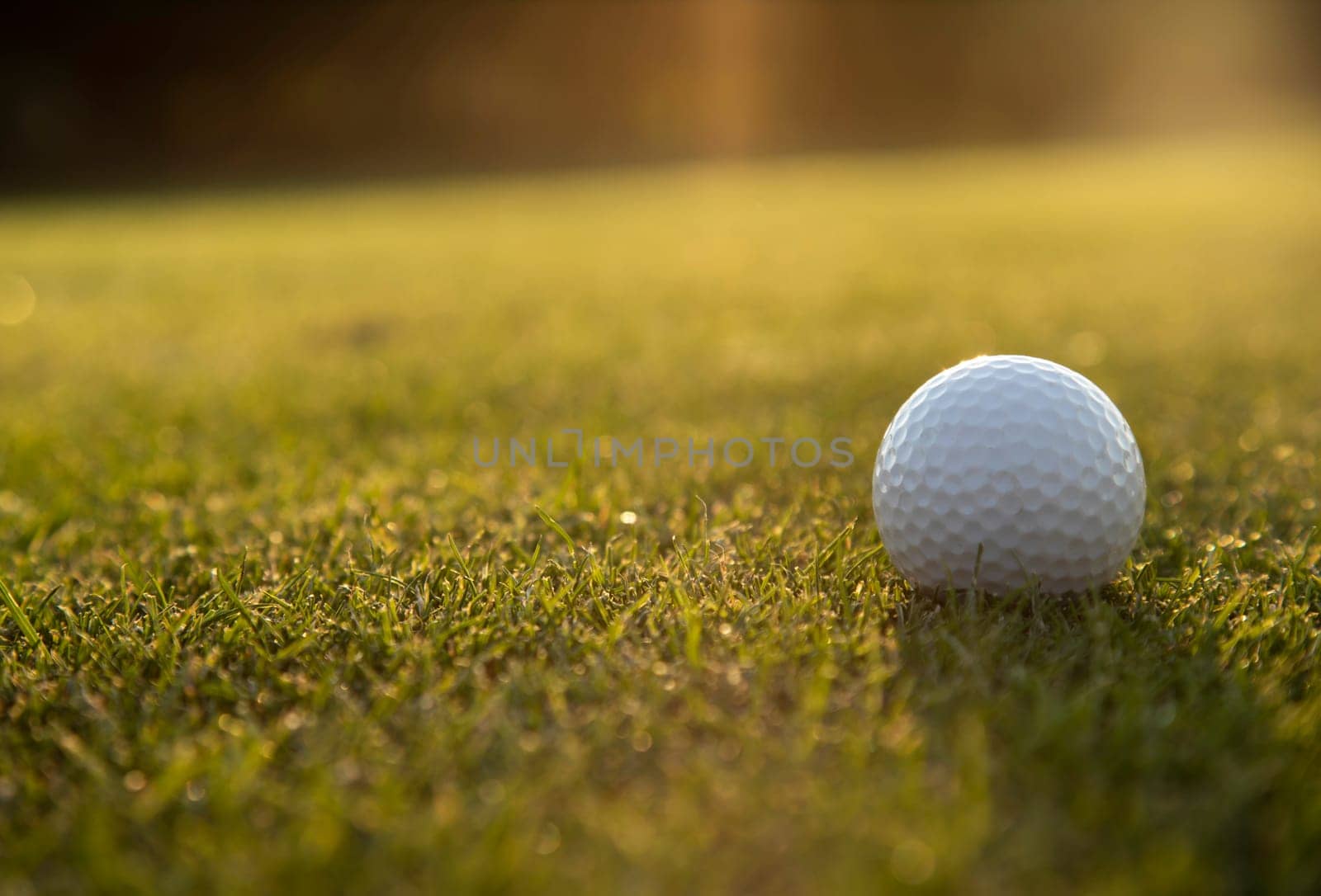 Golf ball and clubs in golf field