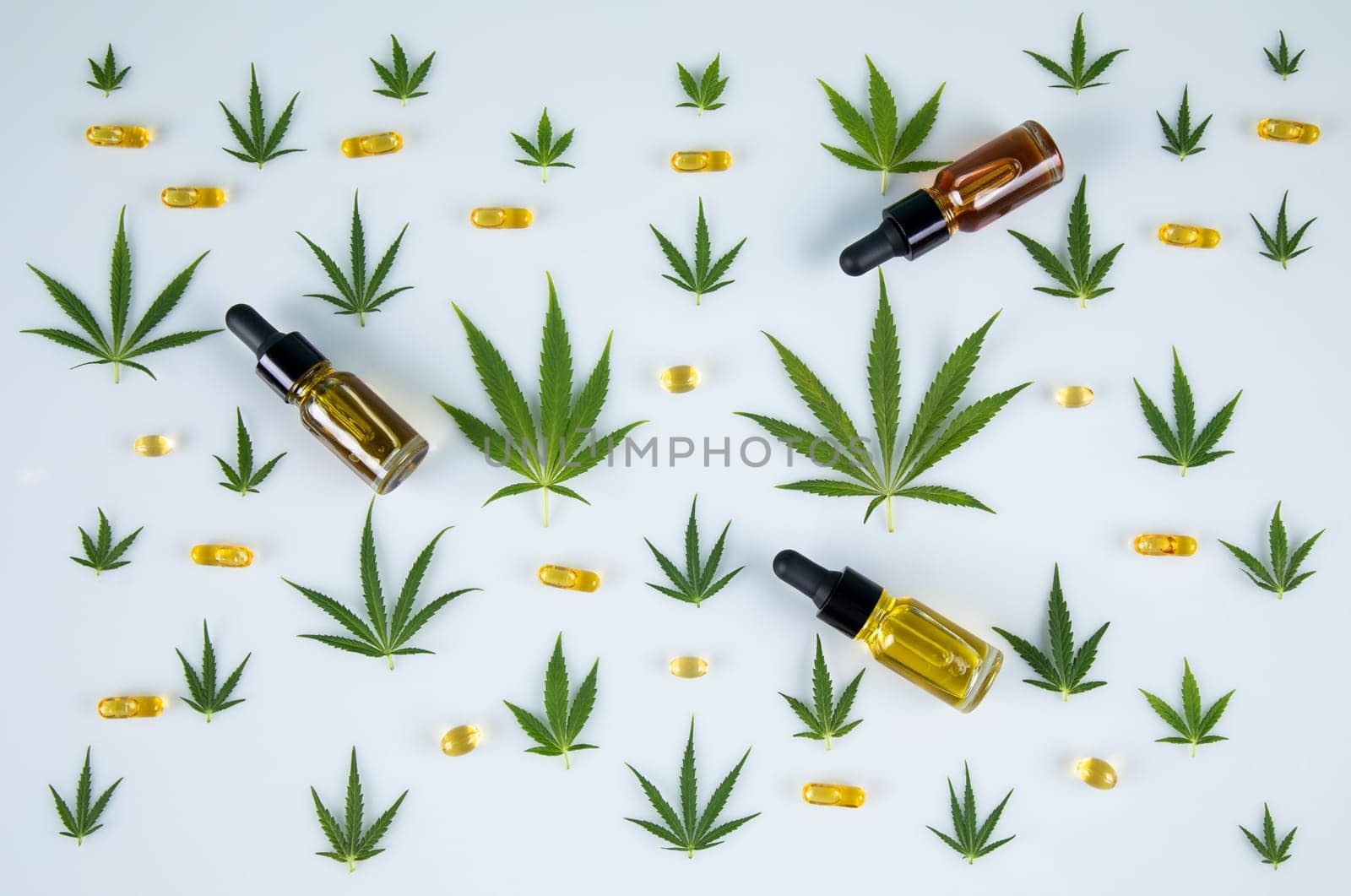 Top view of marijuana leaves and cannabis buds on white background
