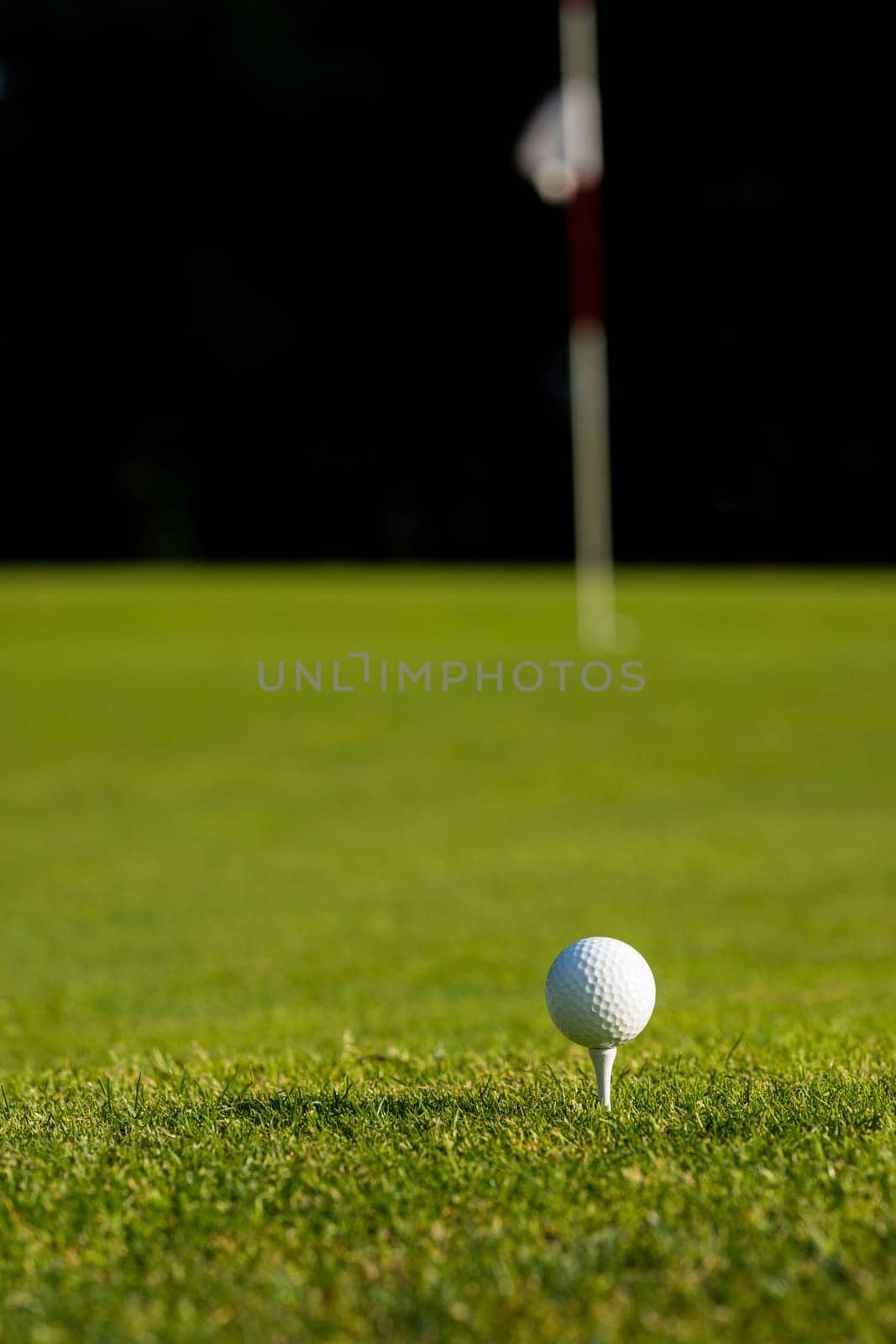 Golf ball and clubs in golf field