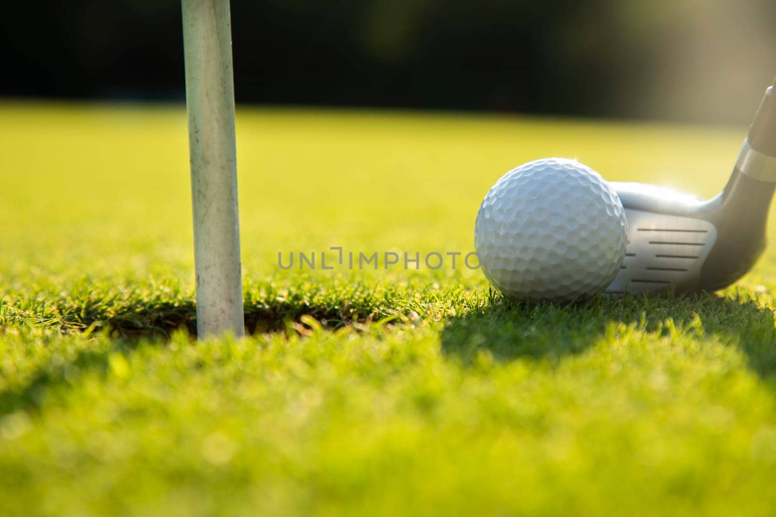 Playing a golf on a beautiful sunset in the evening