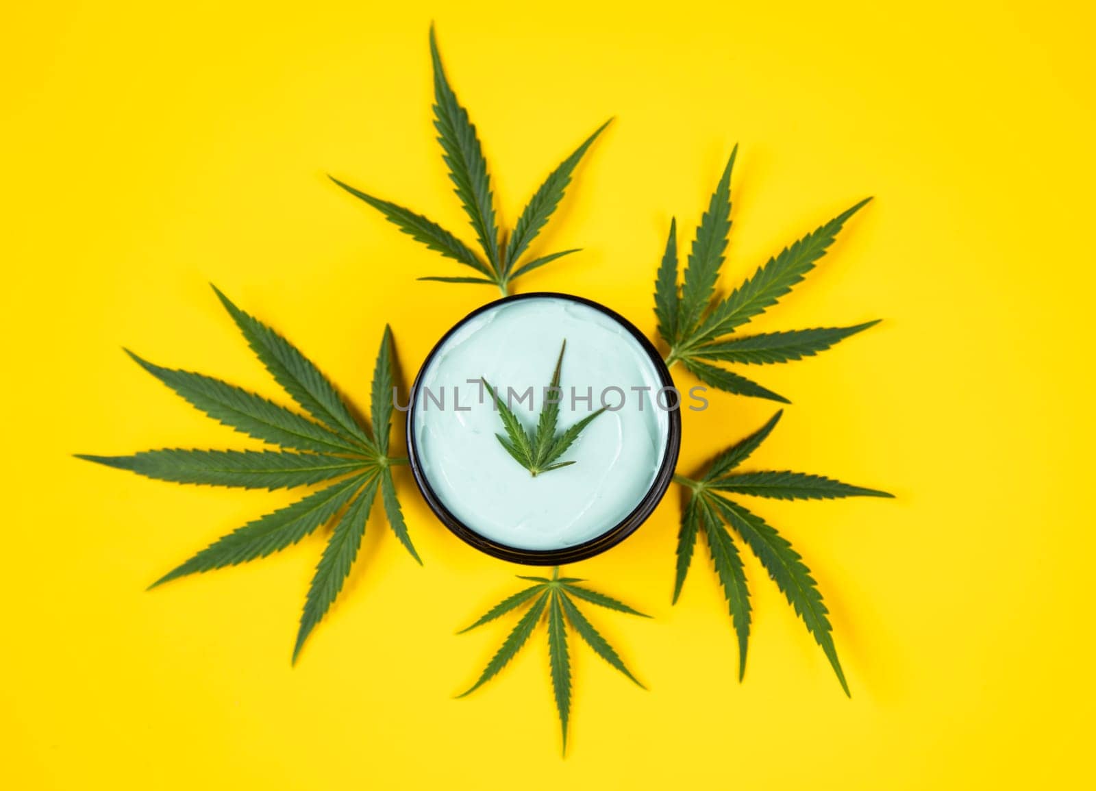 Set of cannabis oil bottles with hemp oil on yellow background. top view. flat lay
