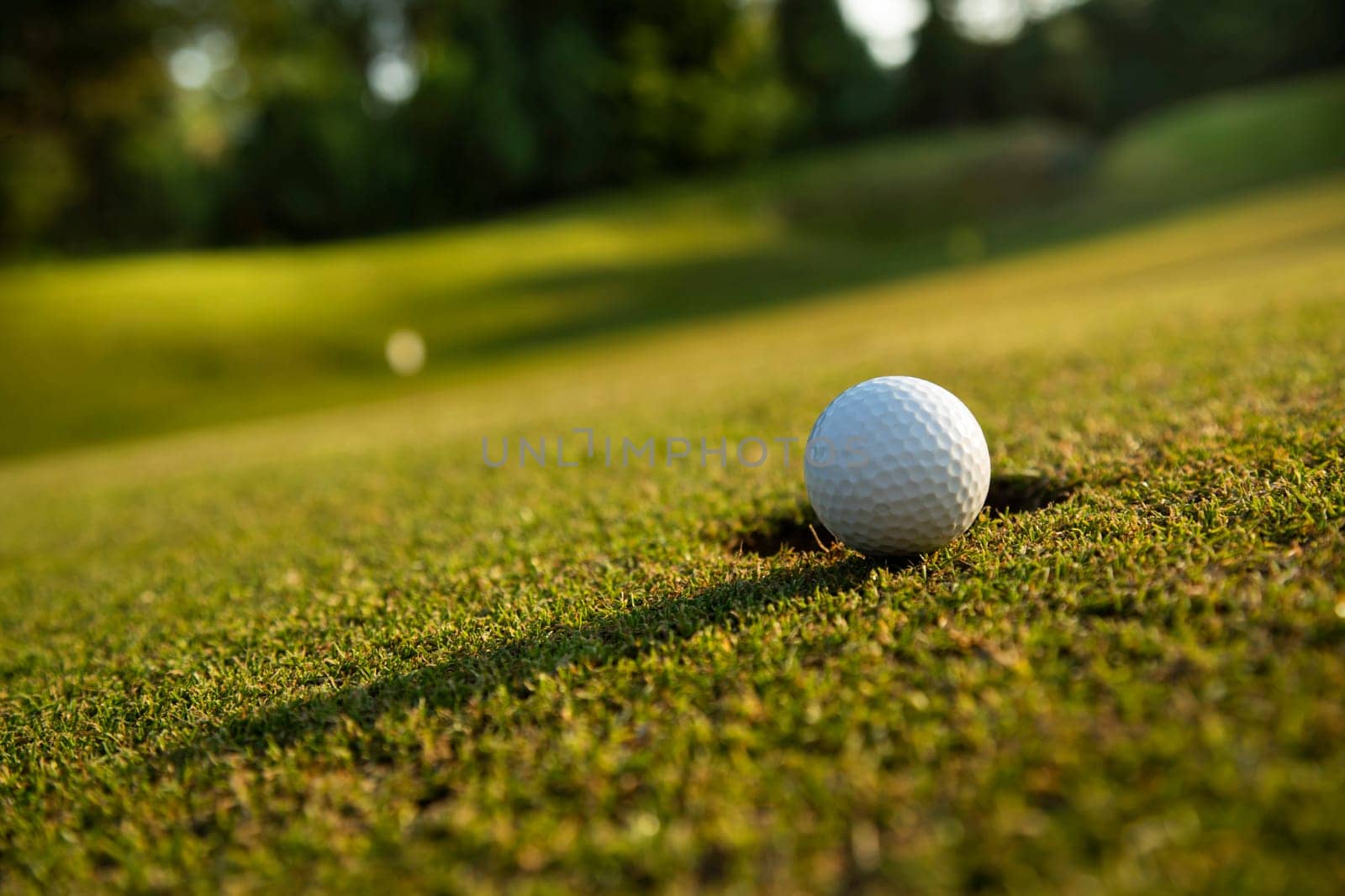 Golf ball and clubs in golf field