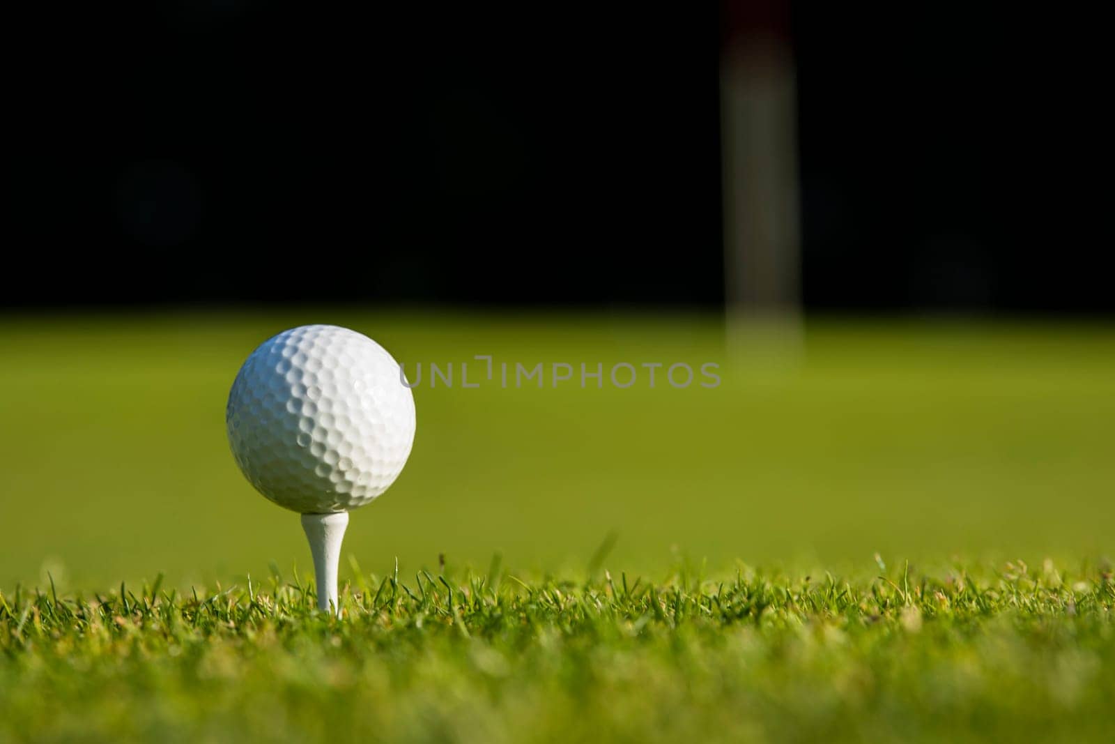 Golf ball and clubs in golf field