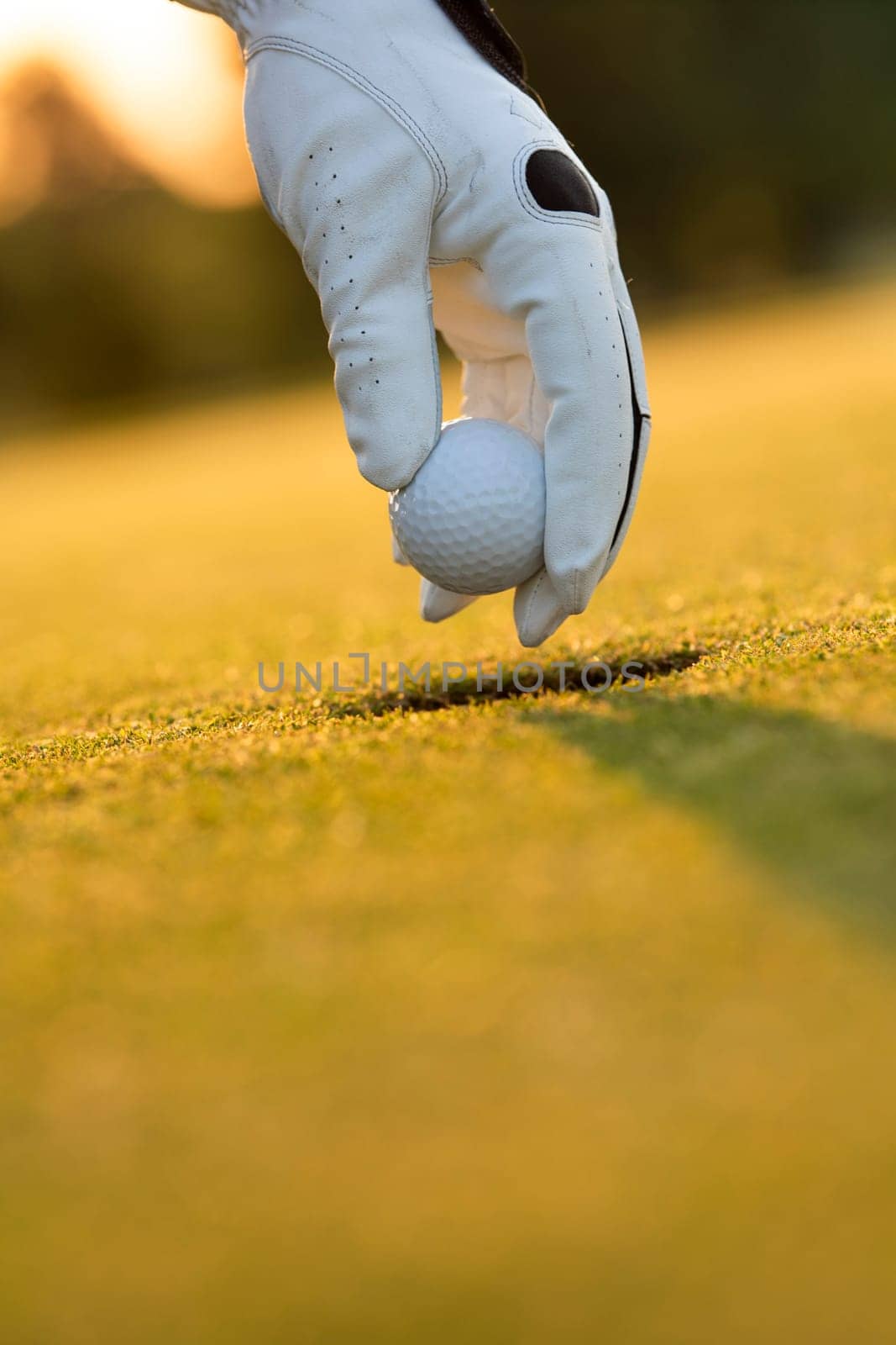 Golf course with ball and grass on close up of a hand     ,grass,golfer,golfing,sky,nature,ball,object,play,blue,fairway,closeup,club,outdoor     ,competition,recreation,background,color,summer
