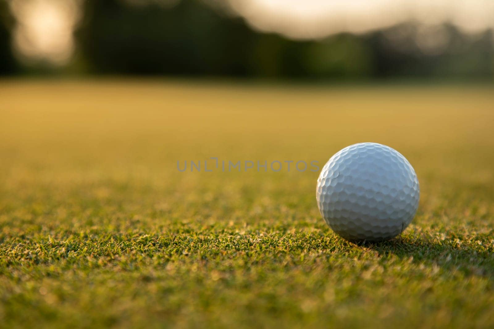 Golf ball and clubs in golf field