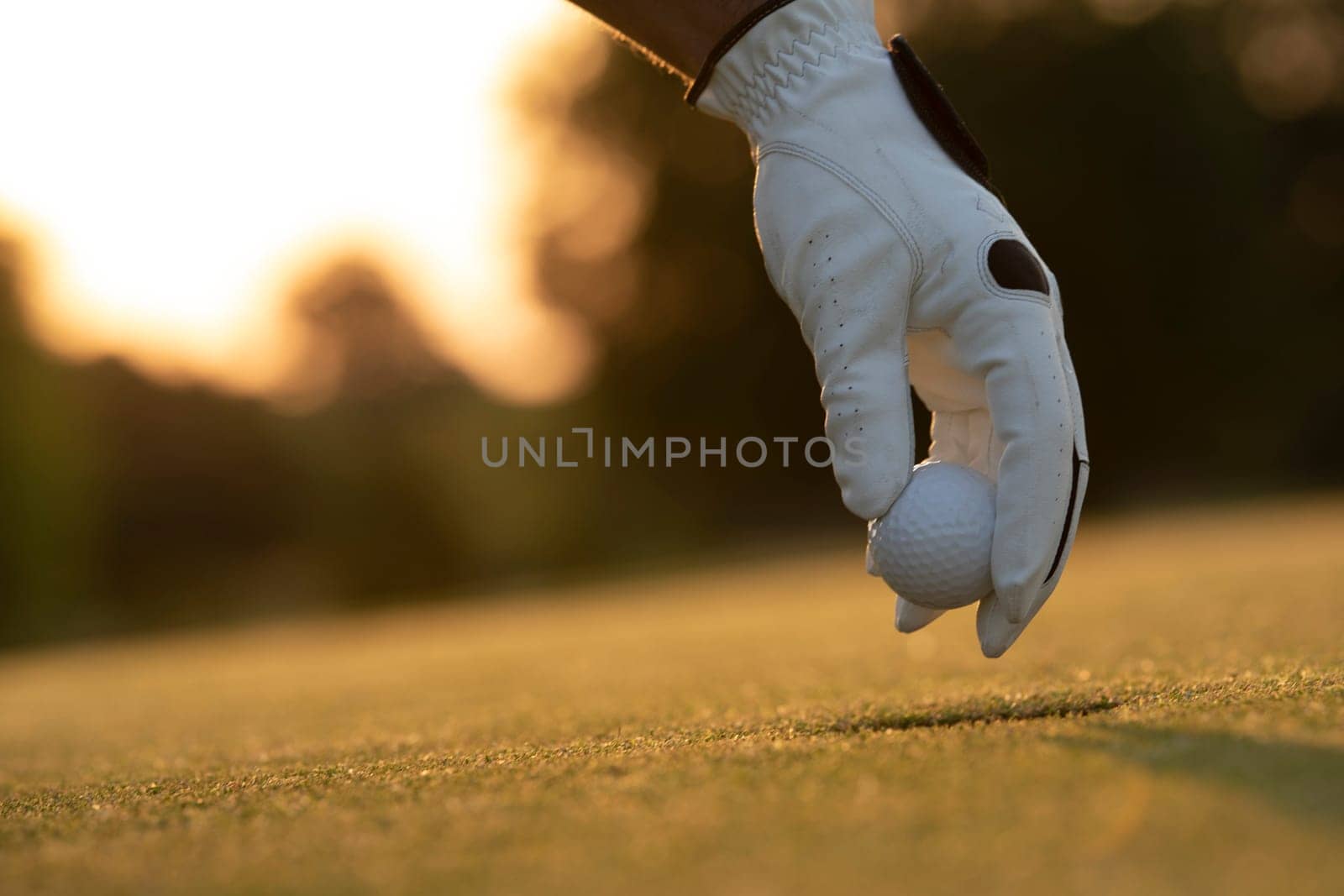 Golf course with ball and grass on close up of a hand     ,grass,golfer,golfing,sky,nature,ball,object,play,blue,fairway,closeup,club,outdoor     ,competition,recreation,background,color,summer